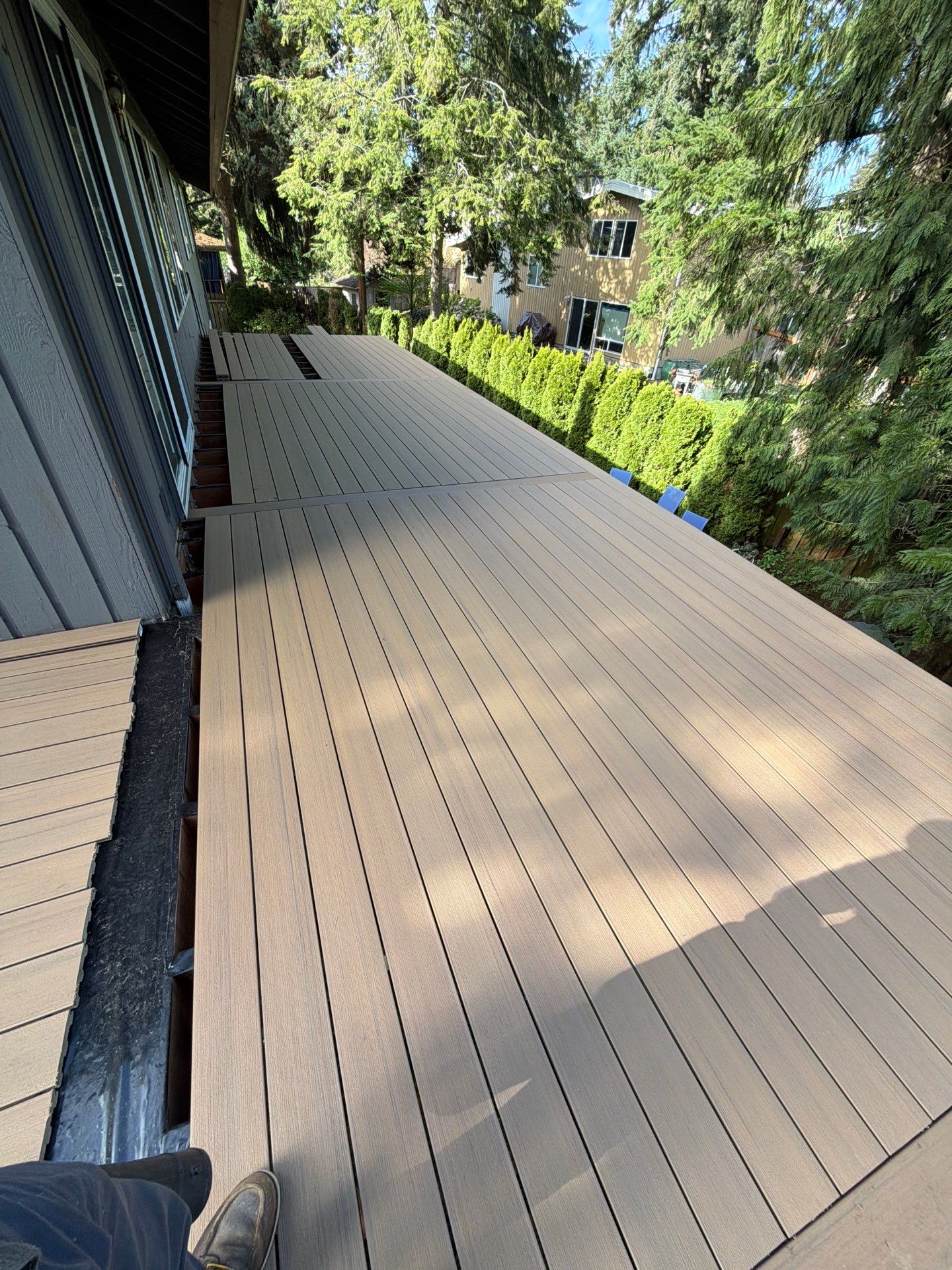 Elevated TimberTech Composite Deck Replacement With Black Metal Railings by Emerald City Energy