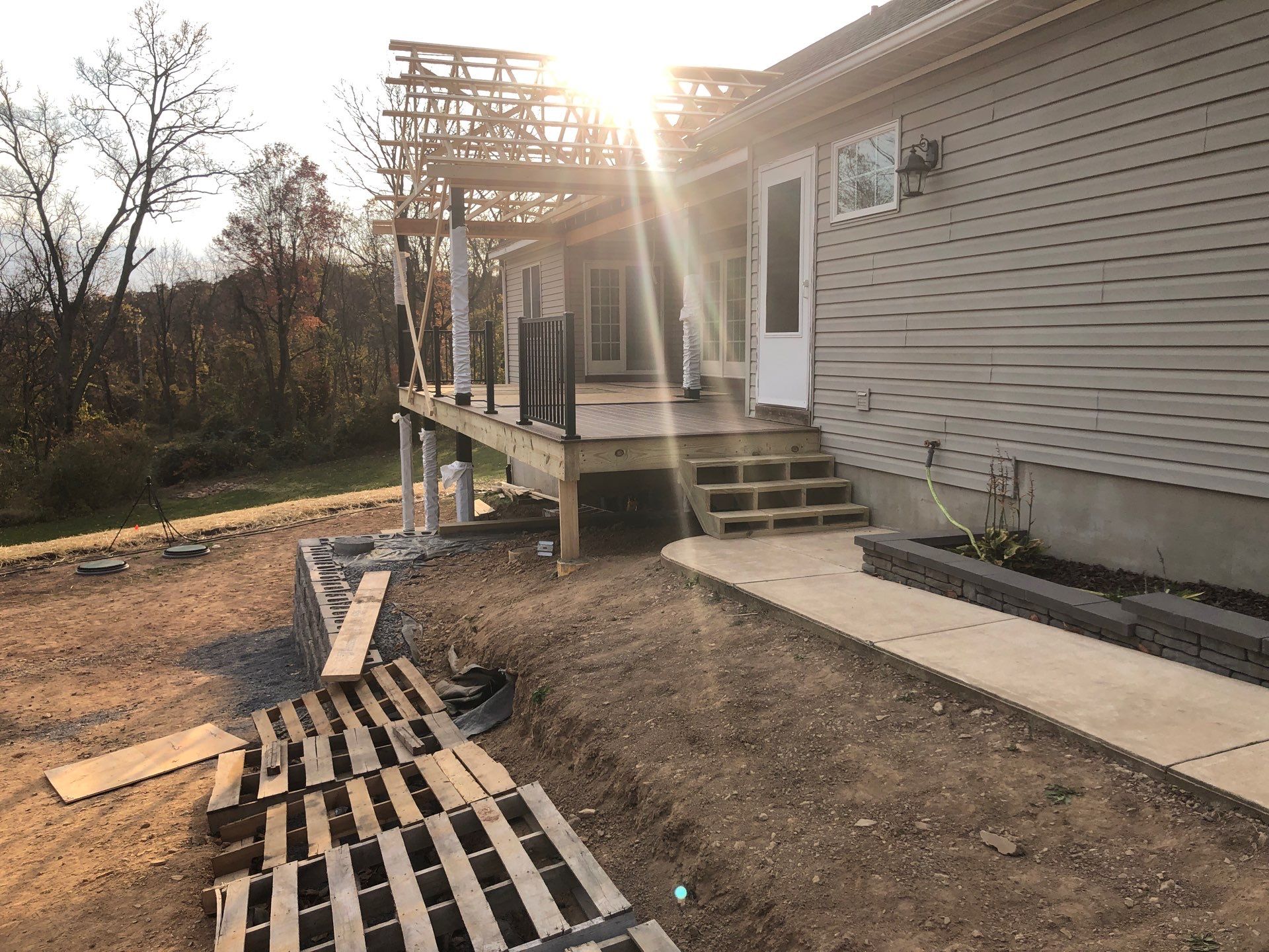 Green Metal Roof and Custom Covered Deck in Duncannon by Esh Builders