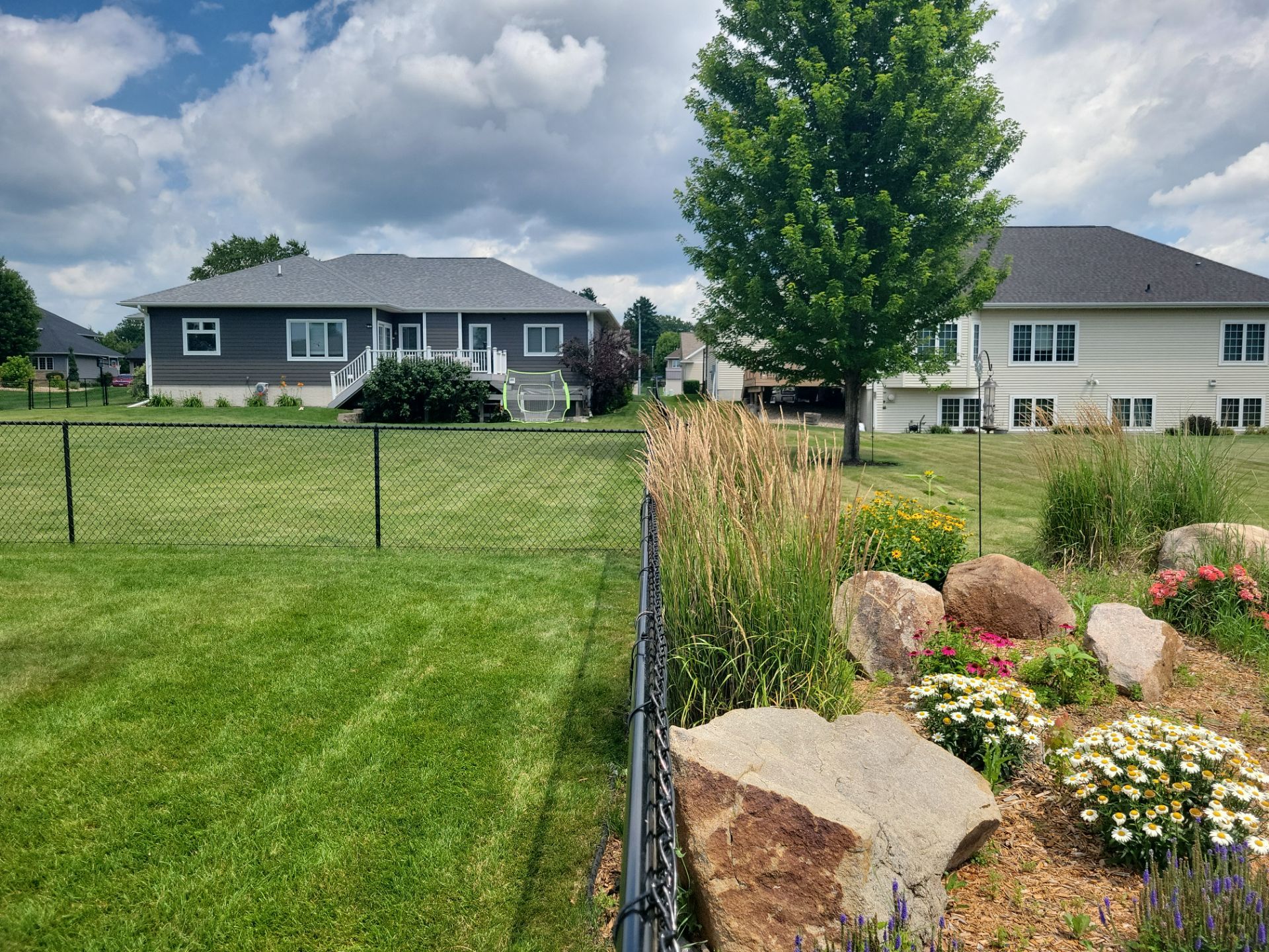 Black Vinyl Coated Chain Link Fence Installation in Cedar Falls by Perfect Picket Fence and Stain