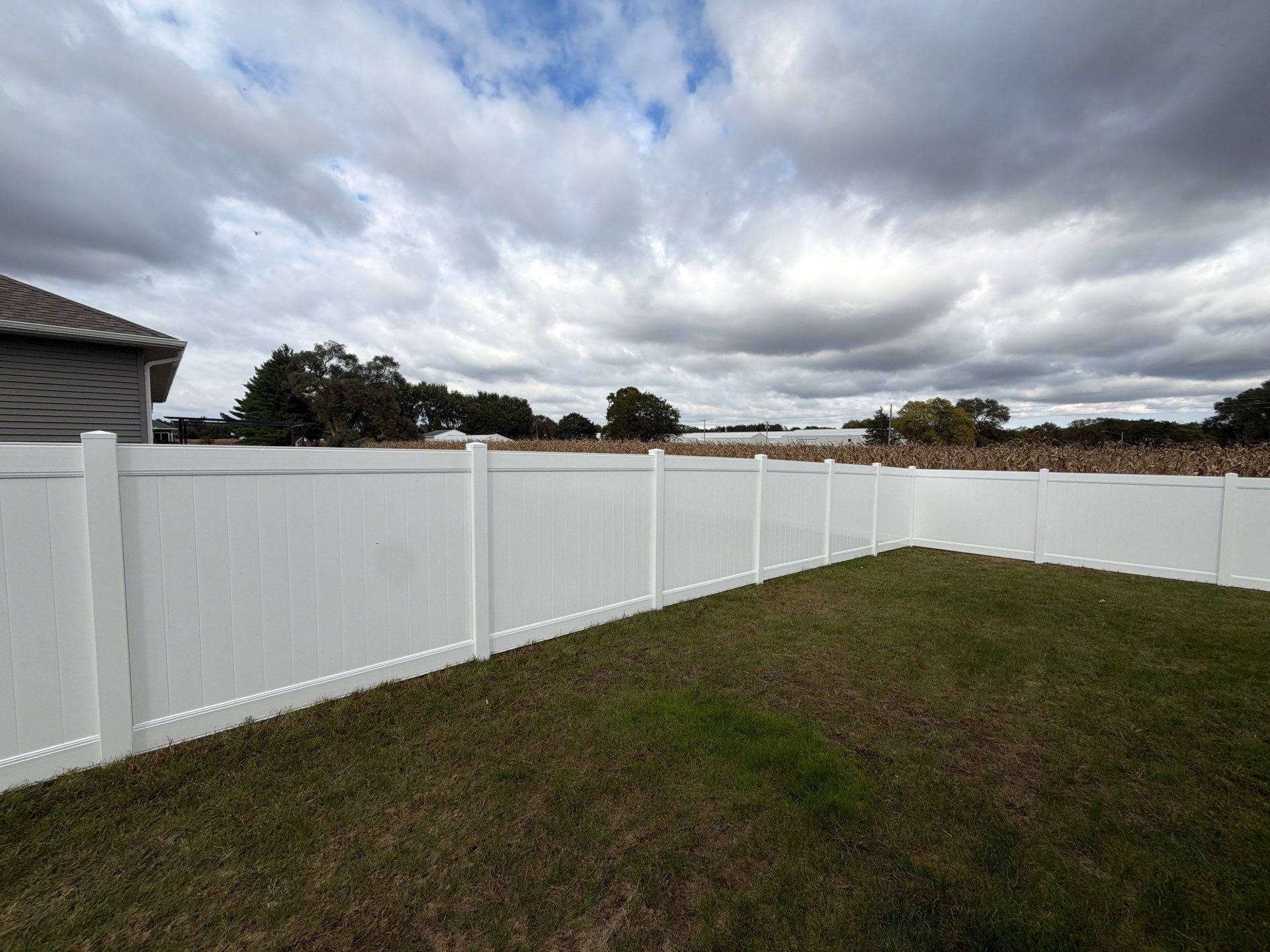 Residential White Vinyl Privacy Fence Installation in Janesville by Perfect Picket Fence and Stain