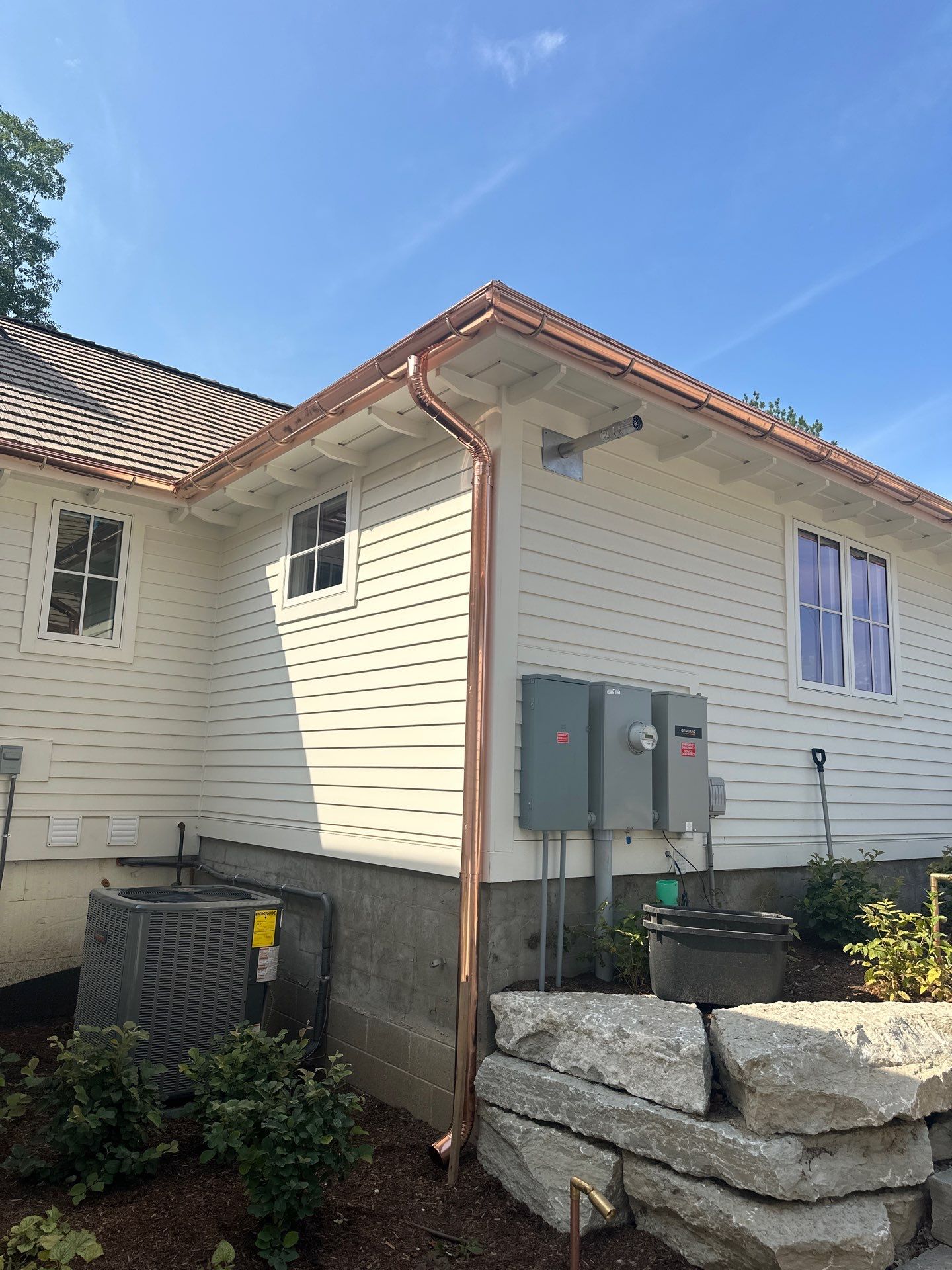 Custom Copper Gutter System and Accent Roofing in East Jordan by Rainbow Seamless Systems