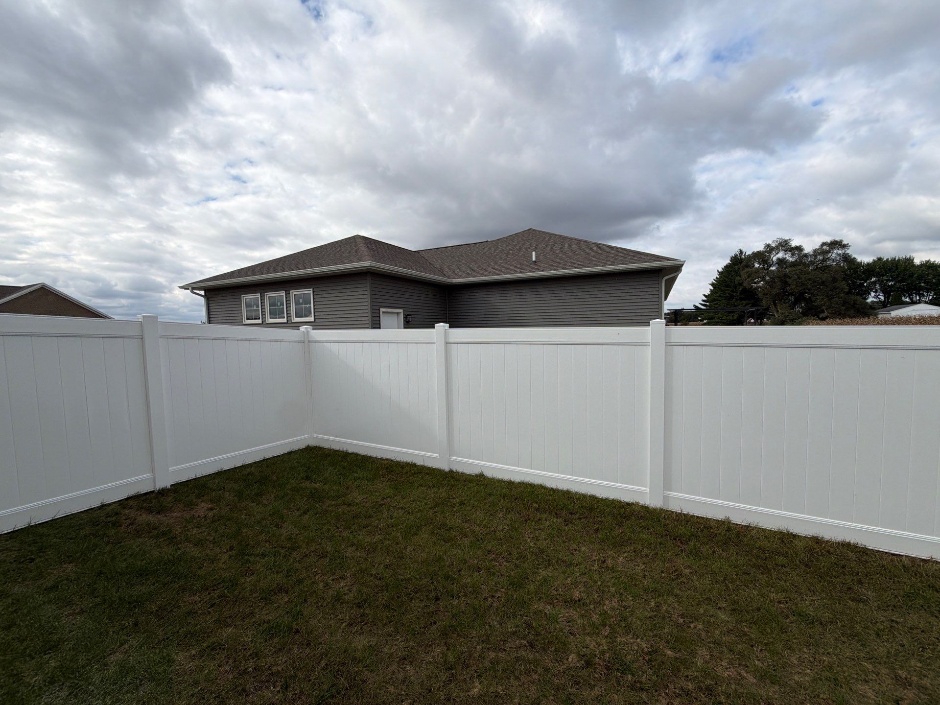 Residential White Vinyl Privacy Fence Installation in Janesville by Perfect Picket Fence and Stain