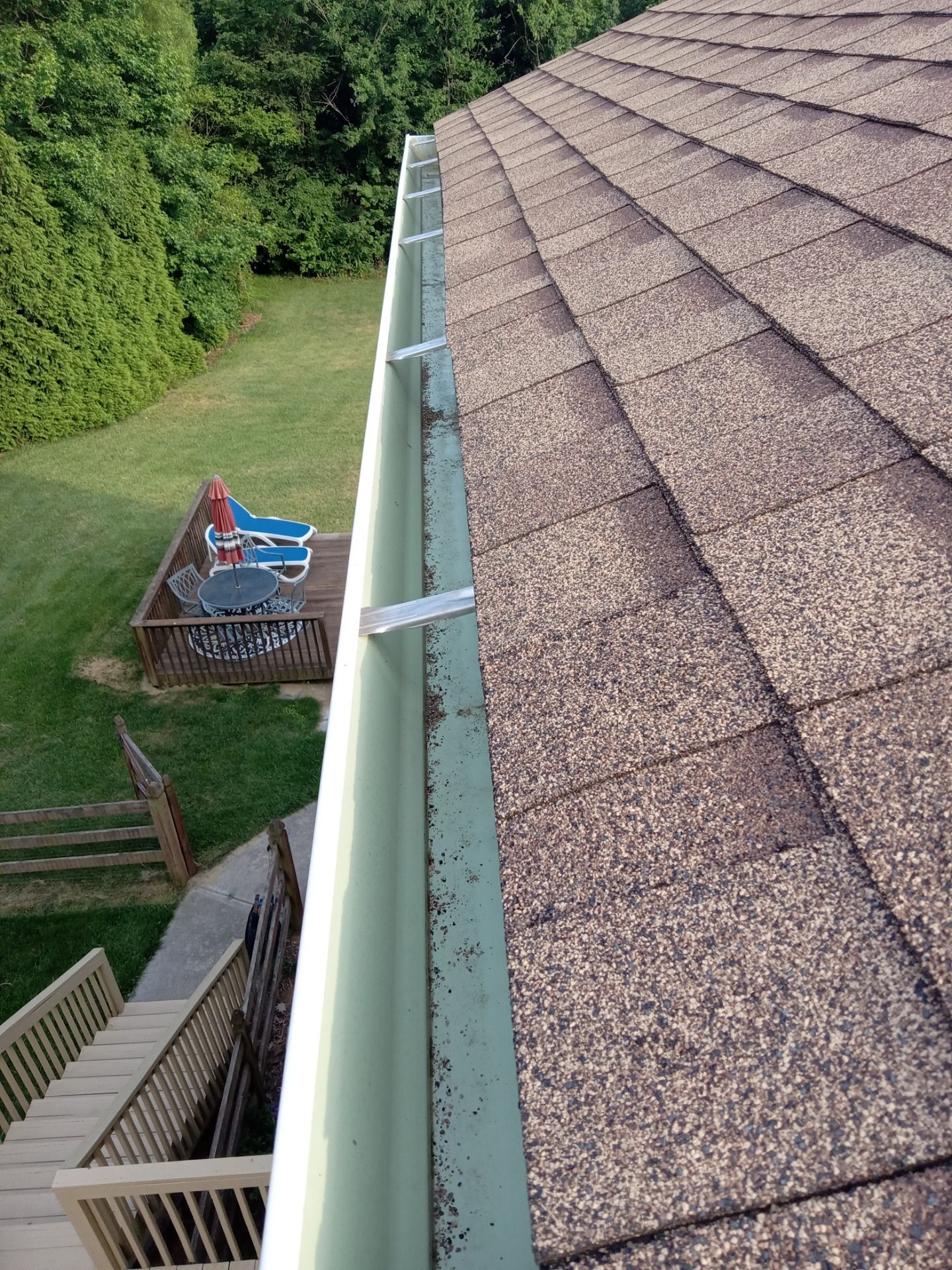 gutter cleaning removing leaves debris from roof drainage system with pressure wash tools