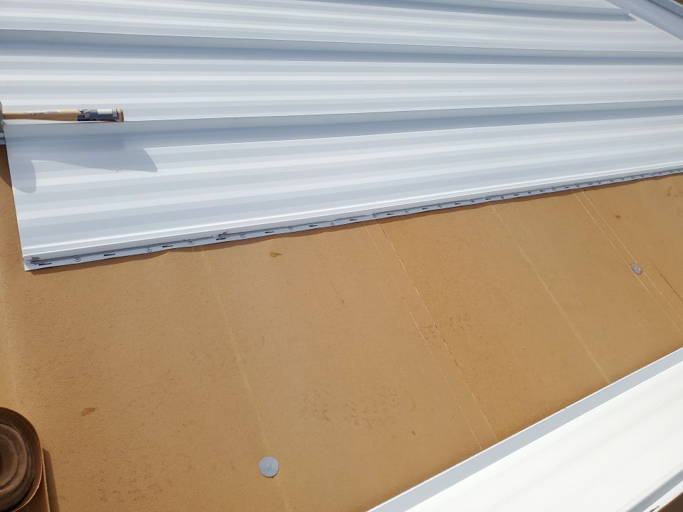 Residential Roofing Installation using 1.5" Nail Strip 24ga Solar White Kynar Coated Standing Seam Metal Panels by Morton Roofing, Inc.
