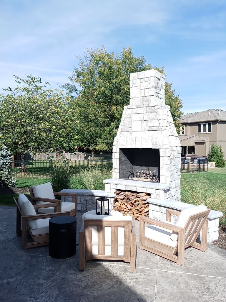 Back Yard Fireplace and Landscape by LAND ESCAPES LLC