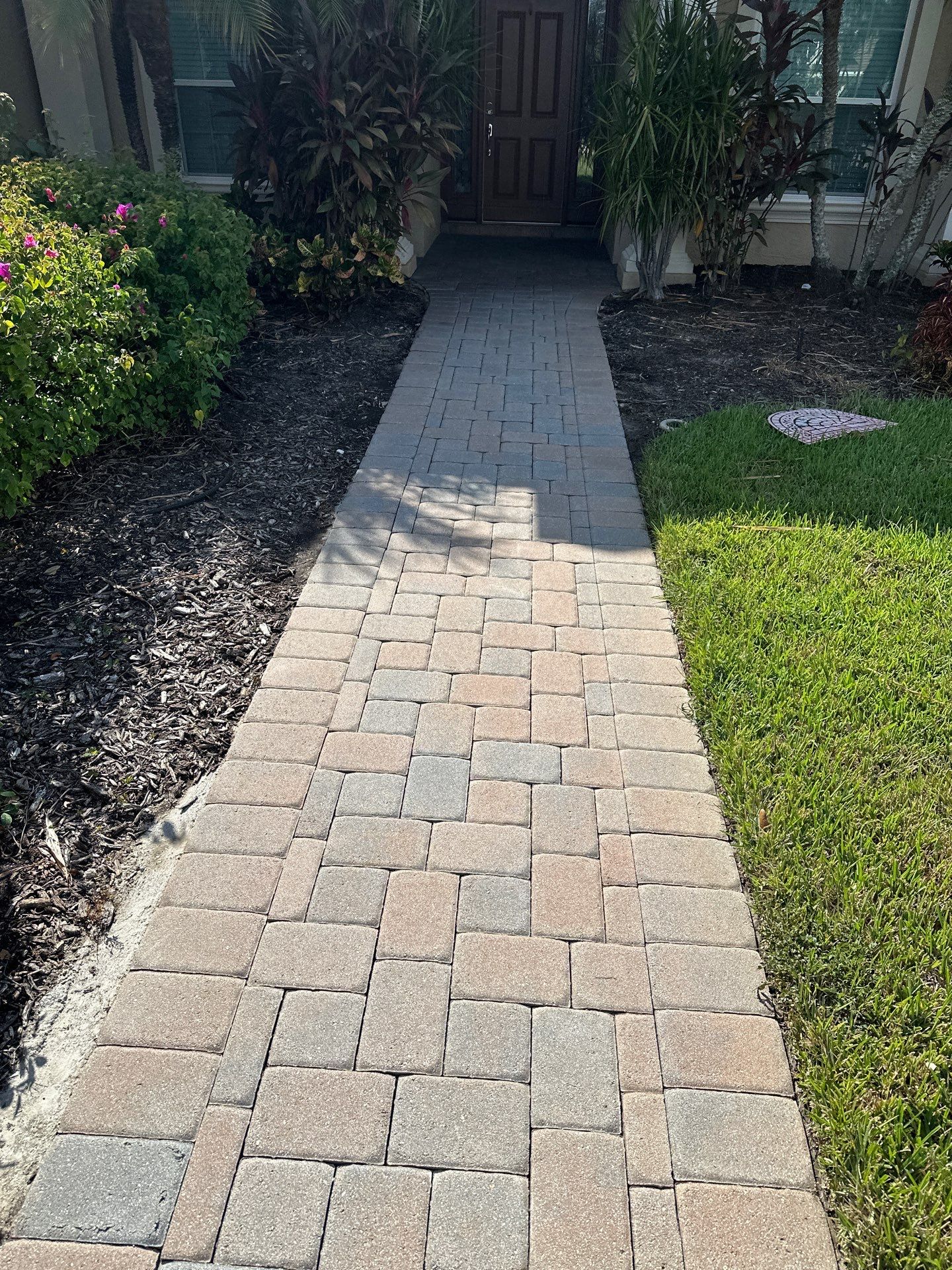 Paver Driveway, Entryway, Sidewalk, and Street Curbing Cleaning in Winding River Community, Bradenton, FL by Sunshine AquaWash