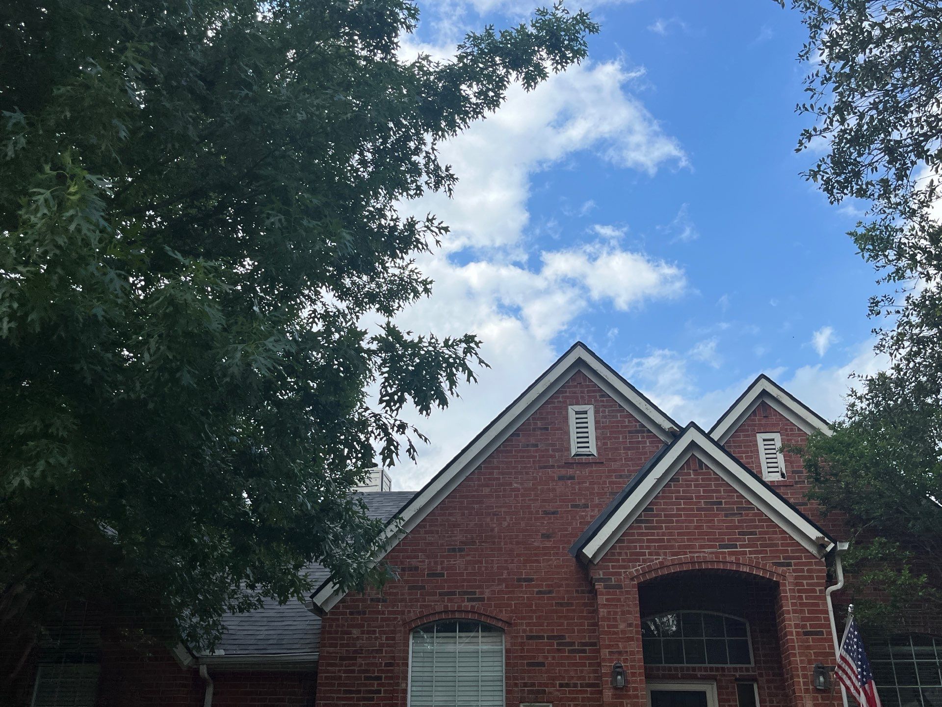 Red brick with Malarkey Midnight Black  by Tejas Roofworks + Restoration