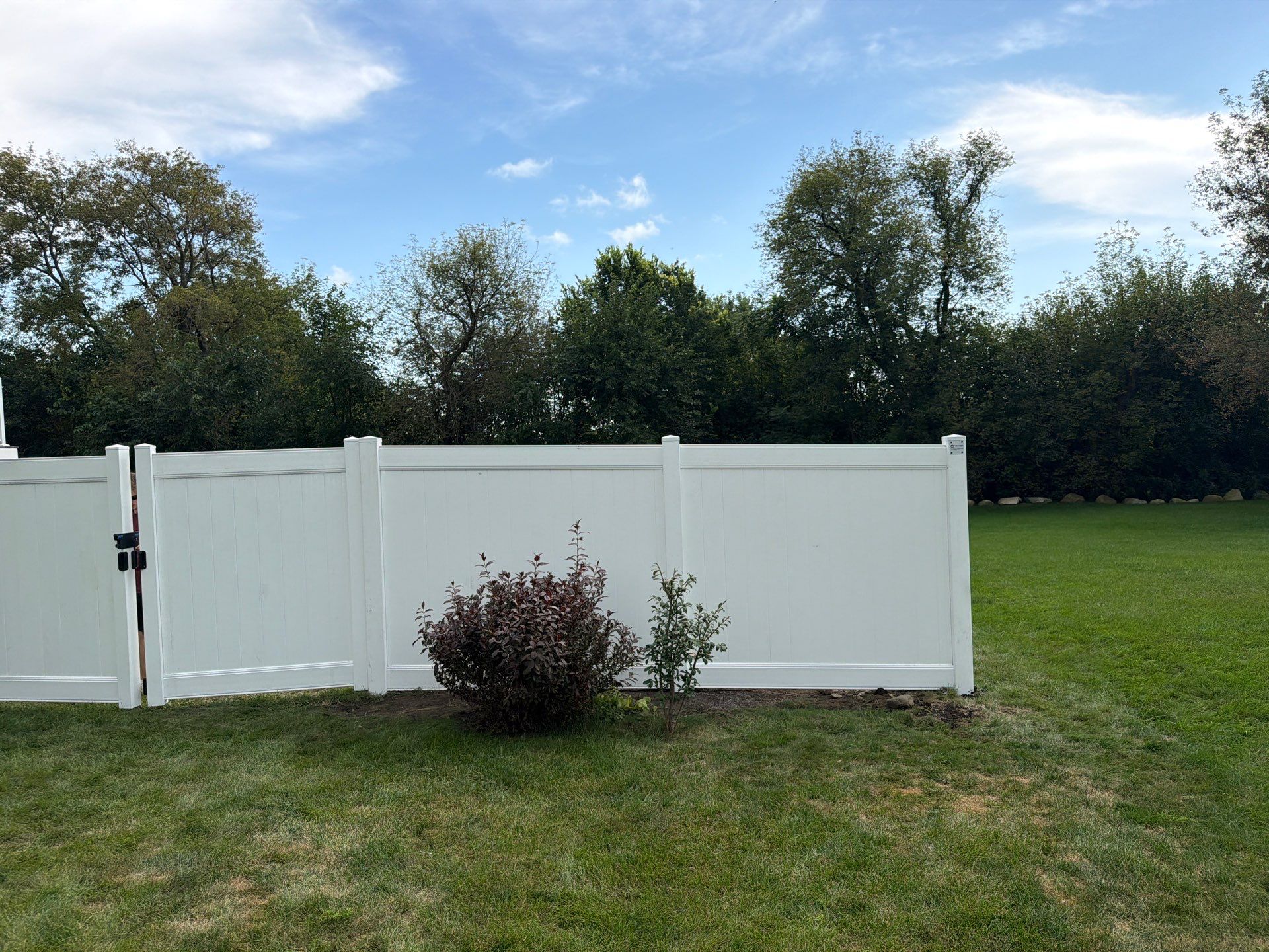 White Vinyl Privacy Fence Installation in Raymond, IA by Perfect Picket Fence and Stain