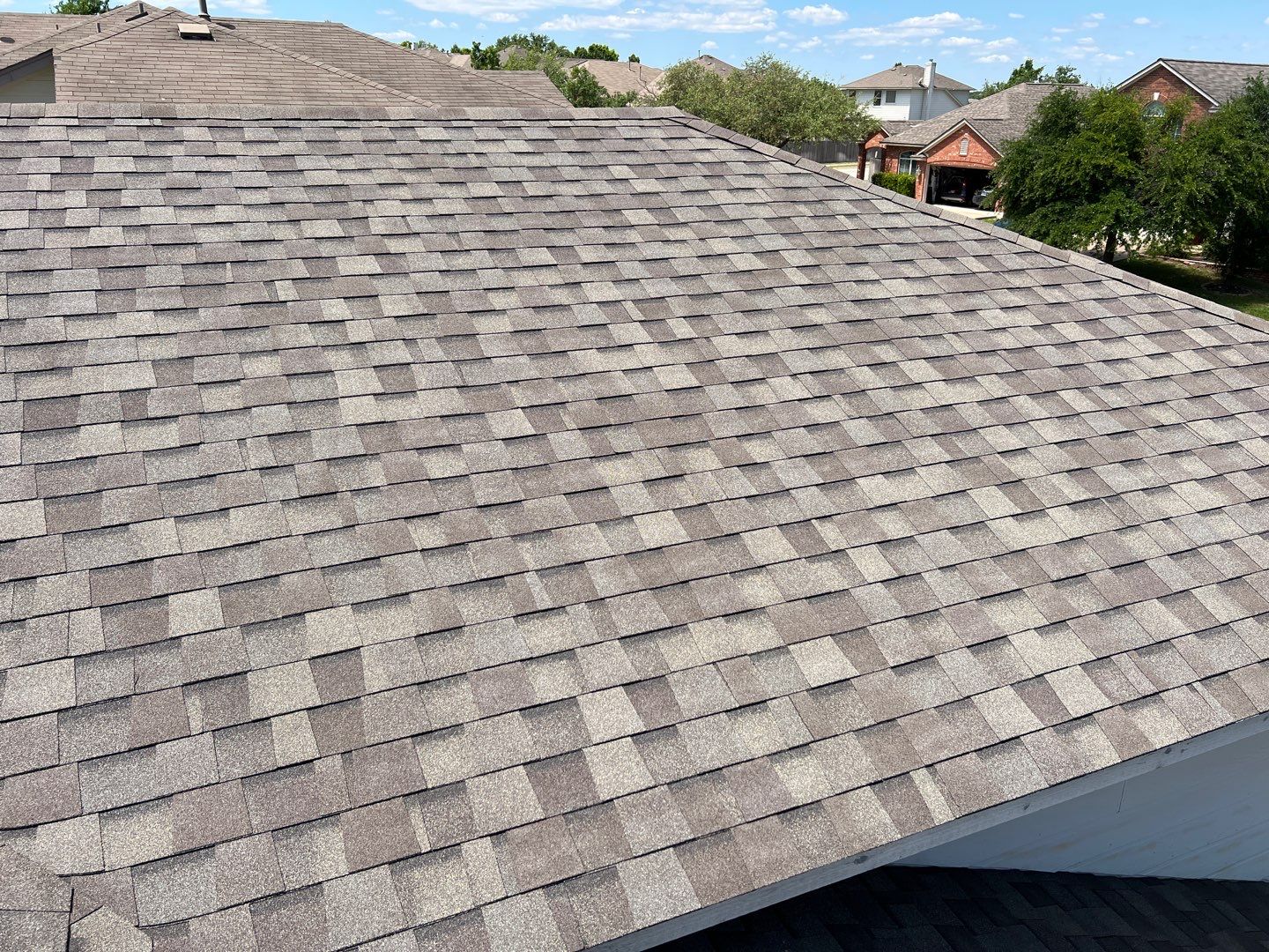 Wind damaged roof replacement by Oakwood Roofing and Construction, LLC