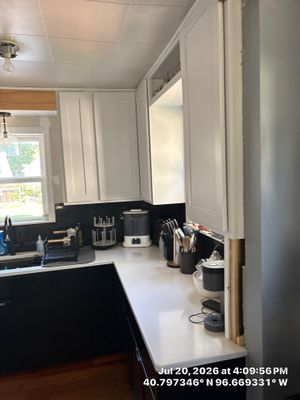 Kitchen Remodel in Lincoln Nebraska Featuring Two-Tone Cabinetry and Black Backsplash