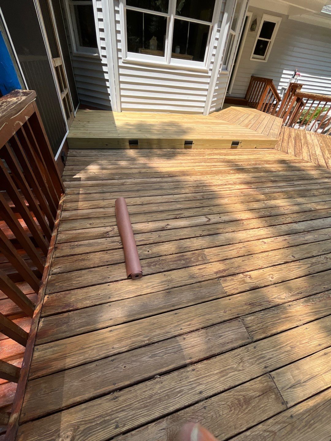 Triple deck re-staining by AKK Painting LLC