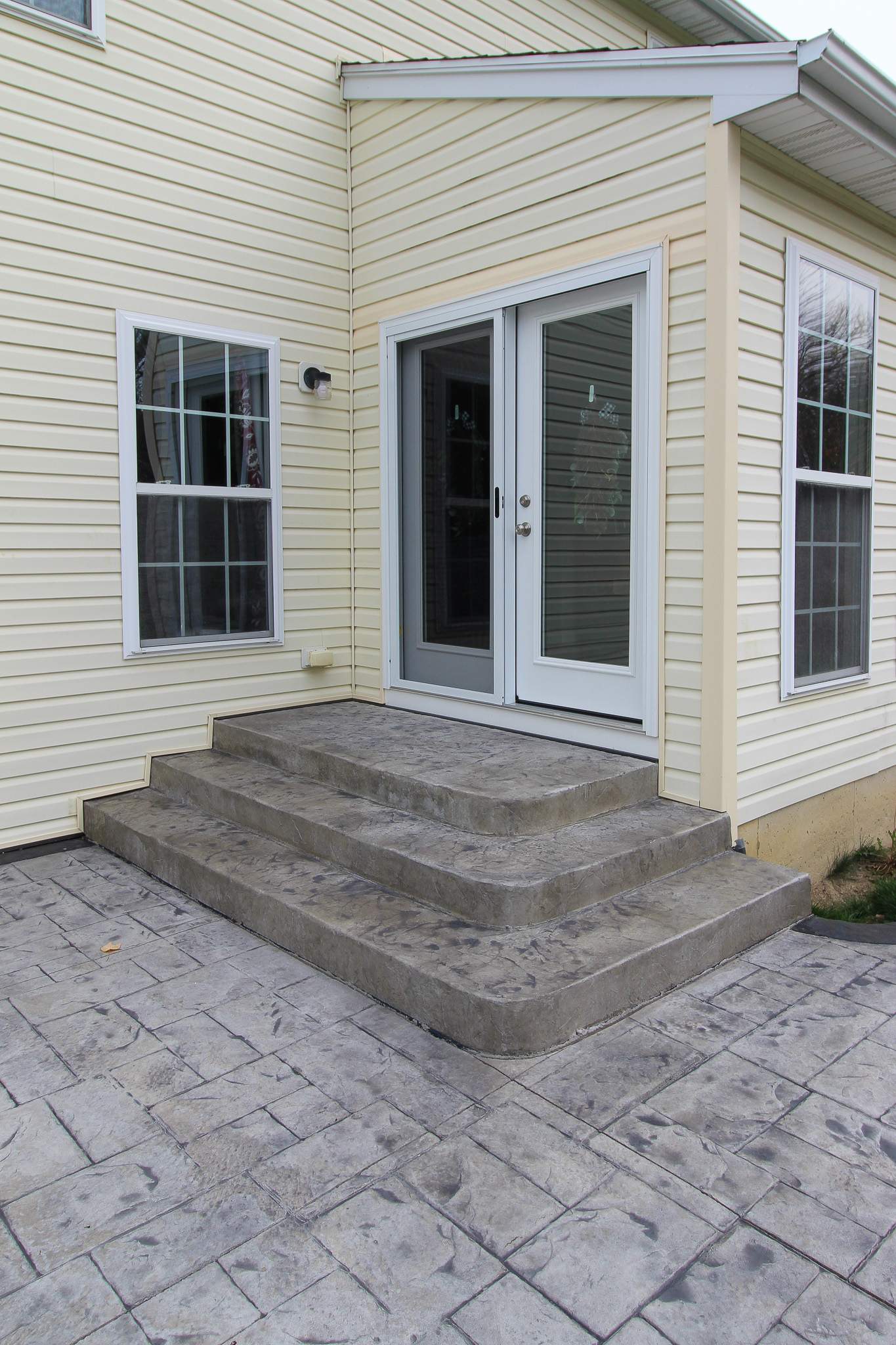 Stamped Concrete, Entry Door, and Concrete  by Ivy Lea Construction