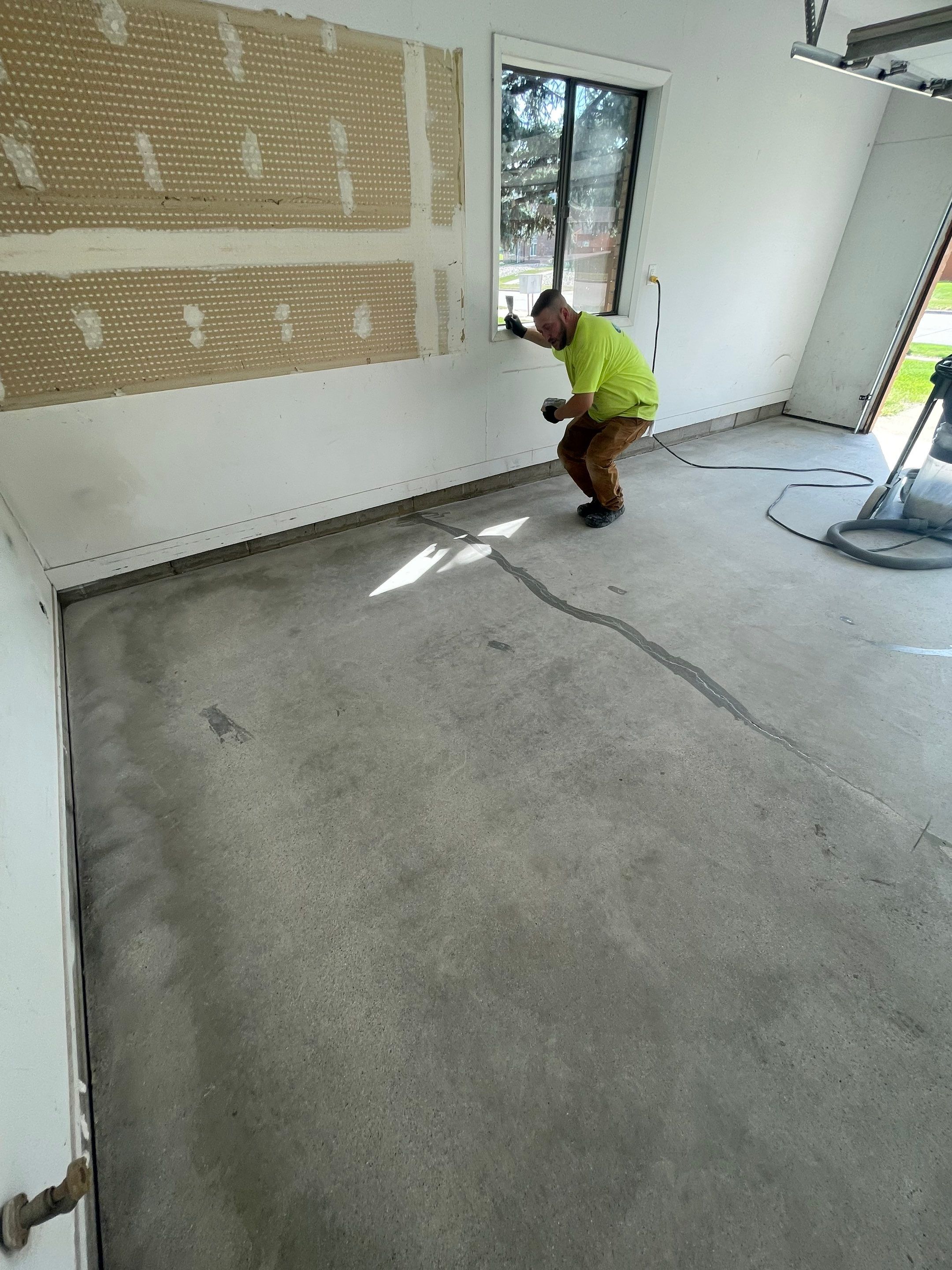Grey Speckled Concrete Coating for Residential Garage in Yankton by Select Painting, Coatings & Garage Cabinets