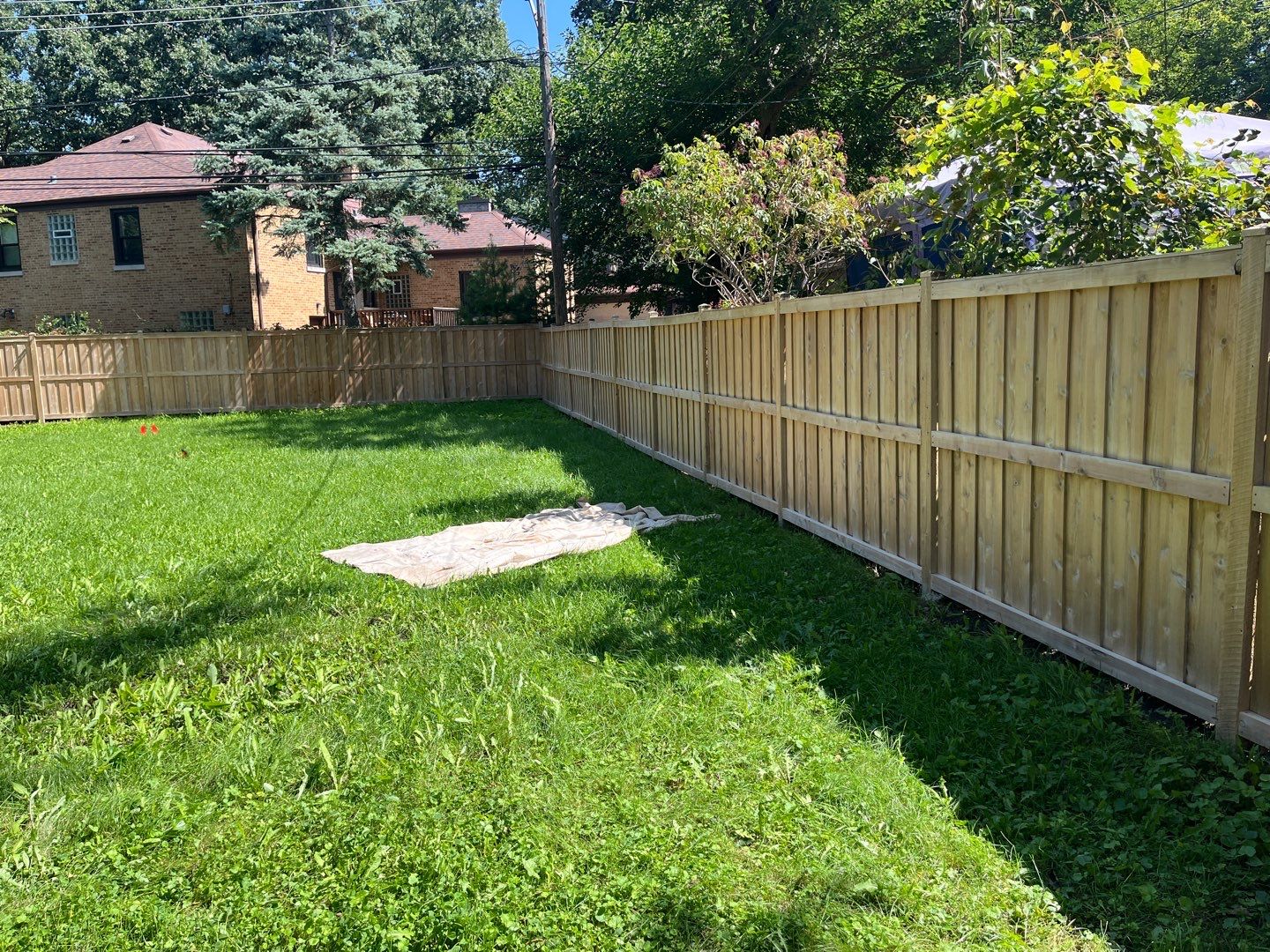 Wood fence cleaning and sealing by Northern Power Washing LLC.