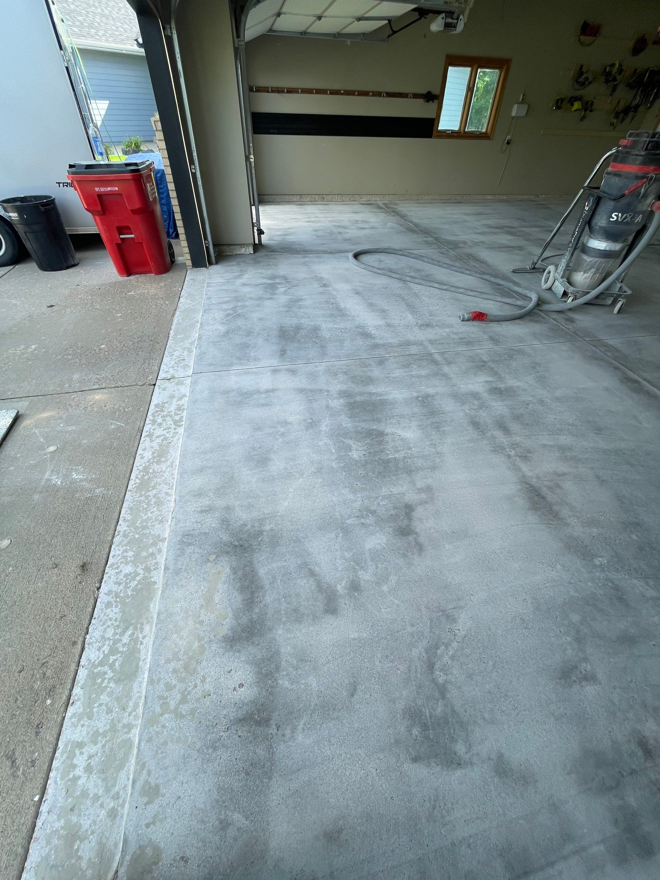 Cabin FEver Flake Garage Floor Coating Installation in Sioux Falls by Select Painting, Coatings & Garage Cabinets