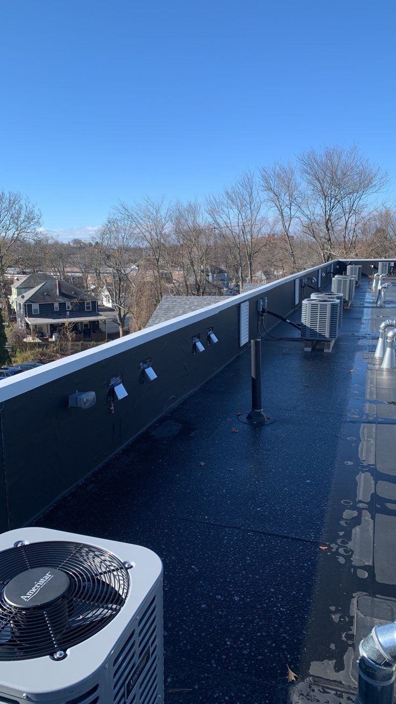 Commercial Roofing Installation using EPDM with white gutters by A Plus Exterior