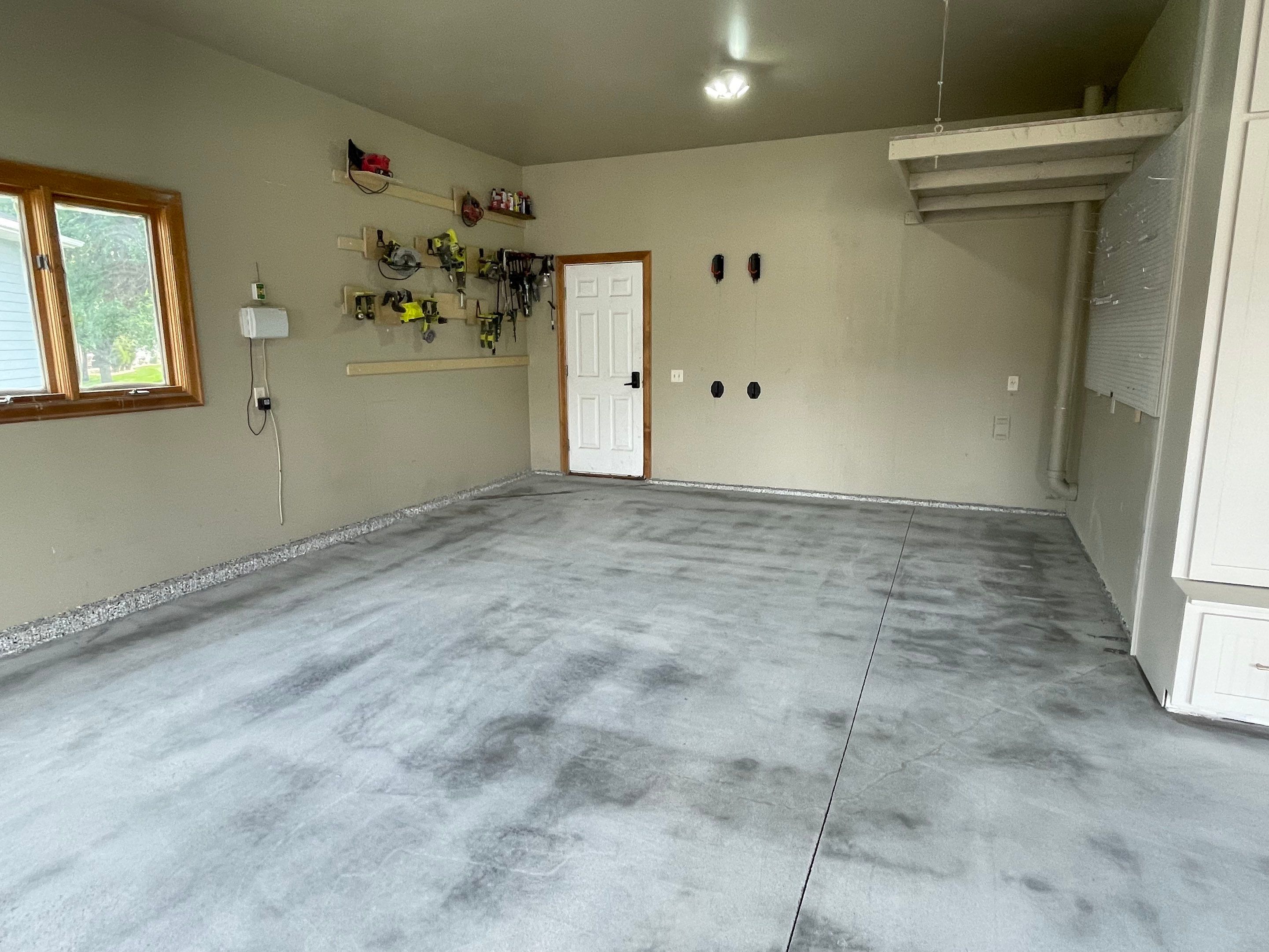 Cabin FEver Flake Garage Floor Coating Installation in Sioux Falls by Select Painting, Coatings & Garage Cabinets