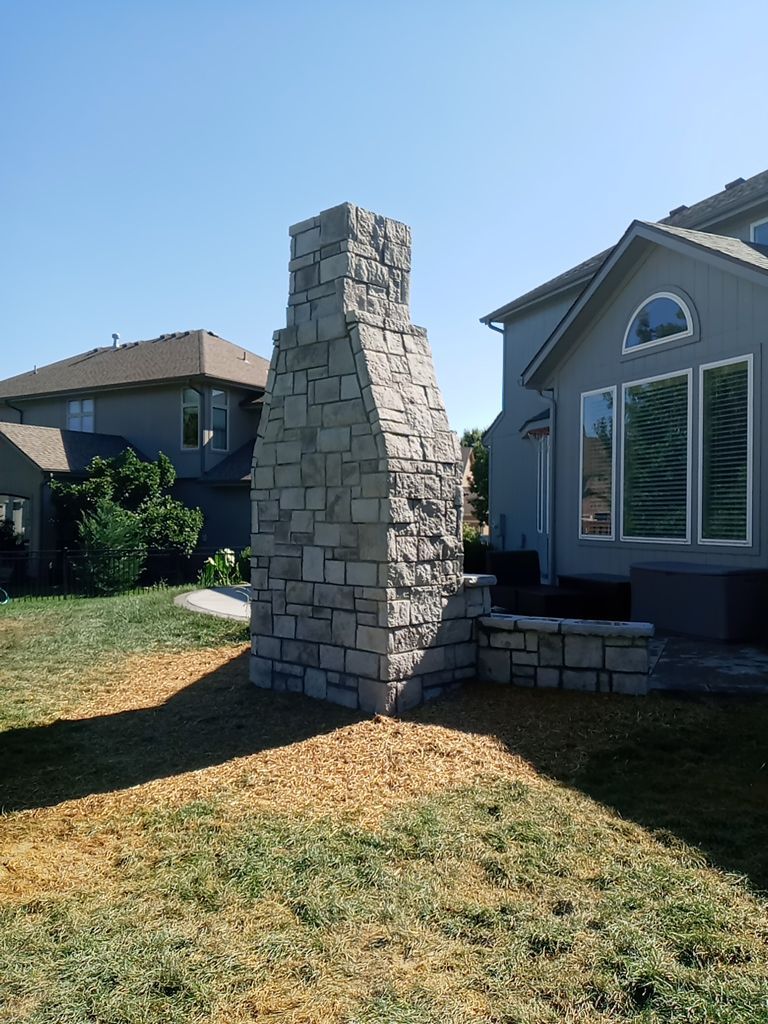 Back Yard Fireplace and Landscape by LAND ESCAPES LLC