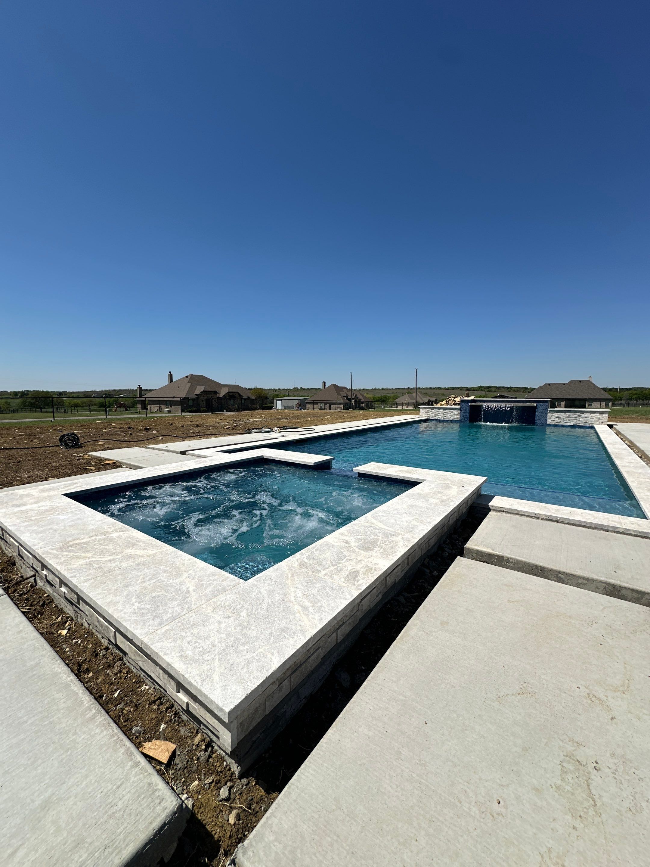 Geometric Pool with Raised Spa and Tanning Ledge by Pinnacle Pools and Spas - DFW