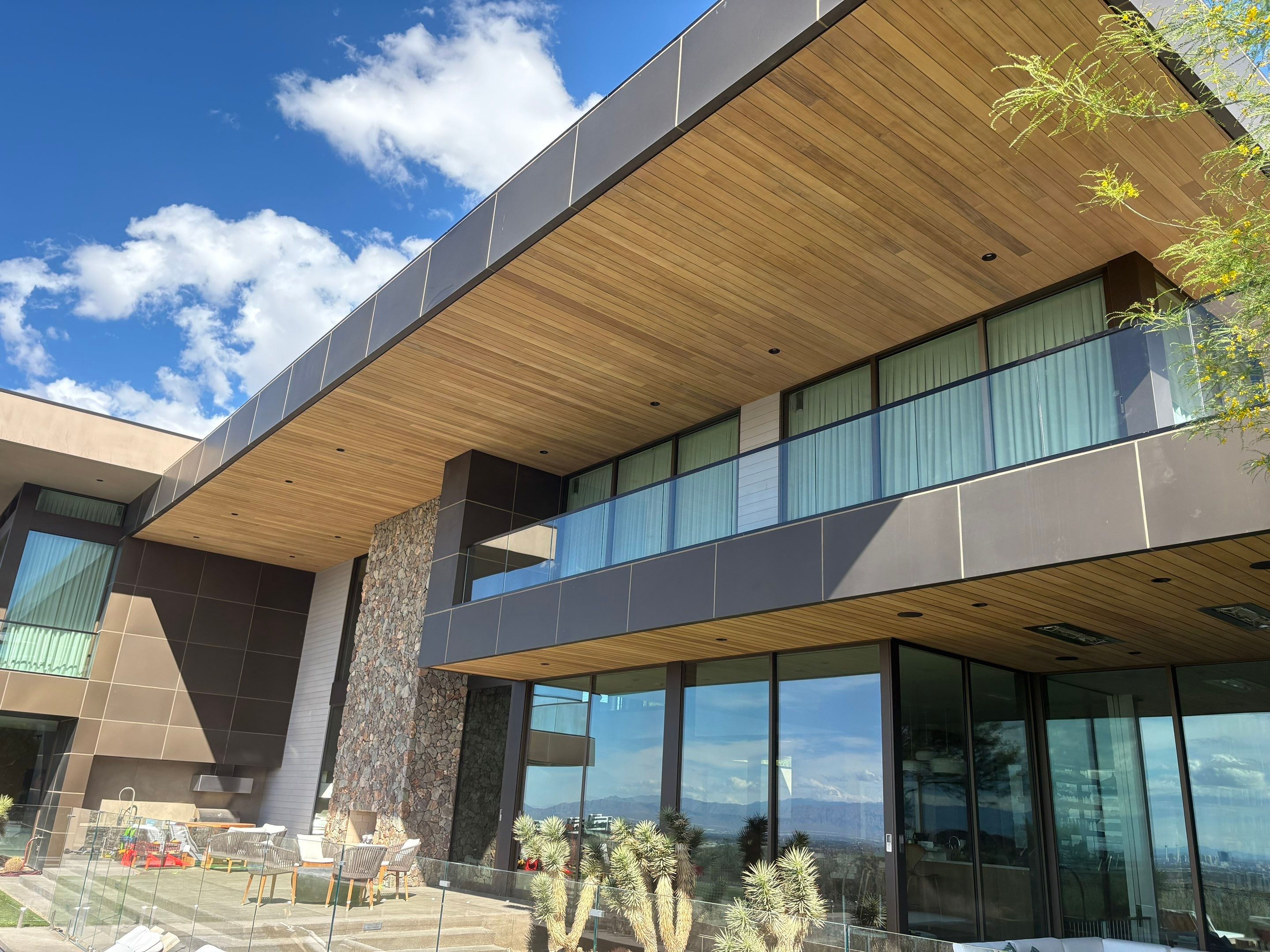 Exterior wood refinish & glass pool enclosure by Level Builders