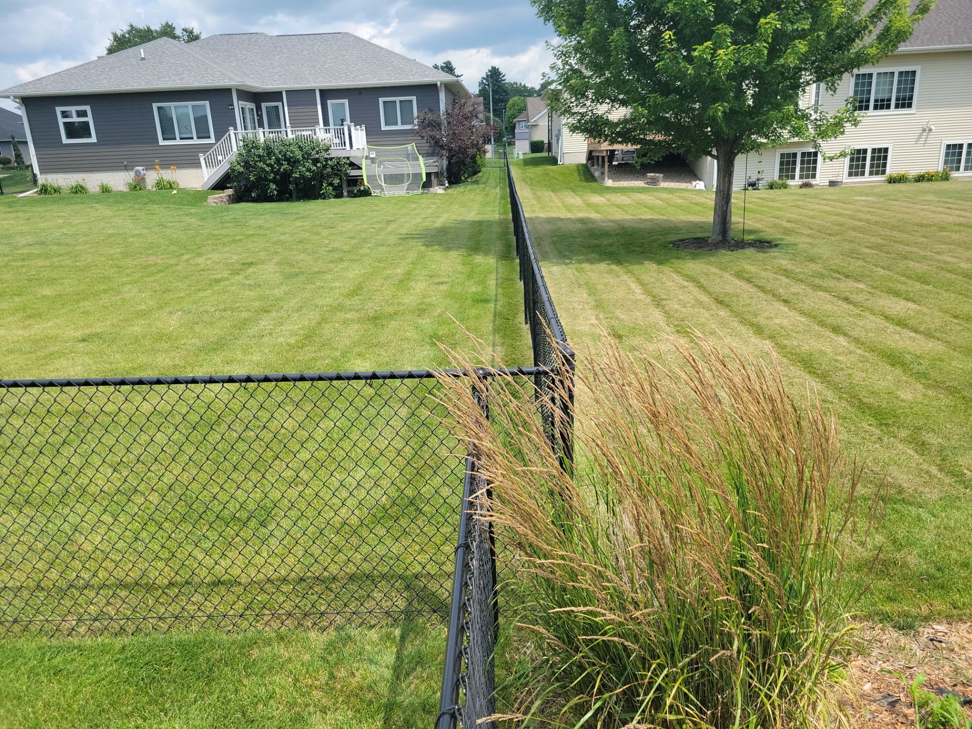 Black Vinyl Coated Chain Link Fence Installation in Cedar Falls by Perfect Picket Fence and Stain