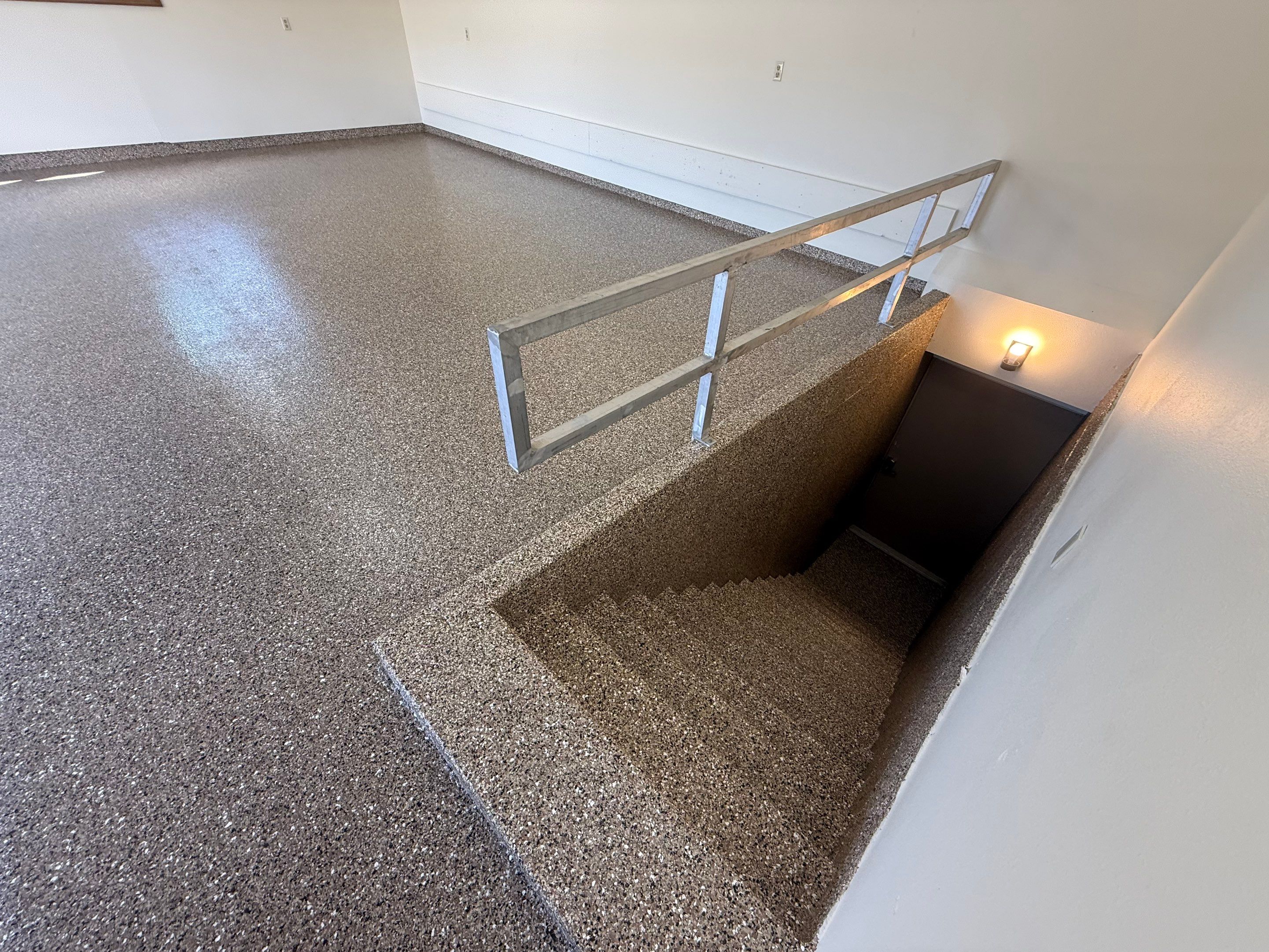Custom Polyaspartic Garage Floor and Stairwell Coating in Pipestone by Select Painting, Coatings & Garage Cabinets
