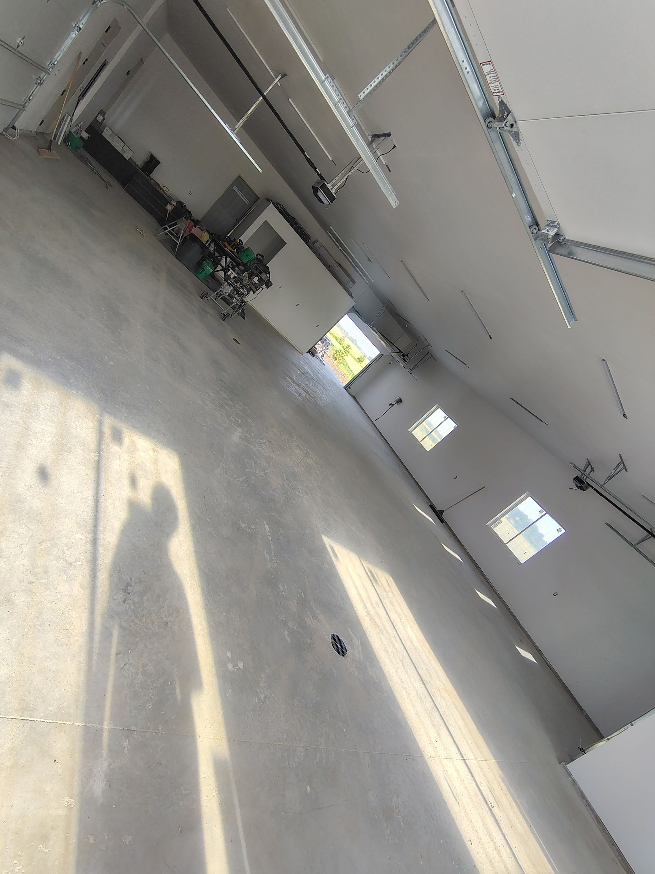 Multi-Bay Garage Concrete Coating and Floor Refinishing in South Dakota by Select Painting, Coatings & Garage Cabinets