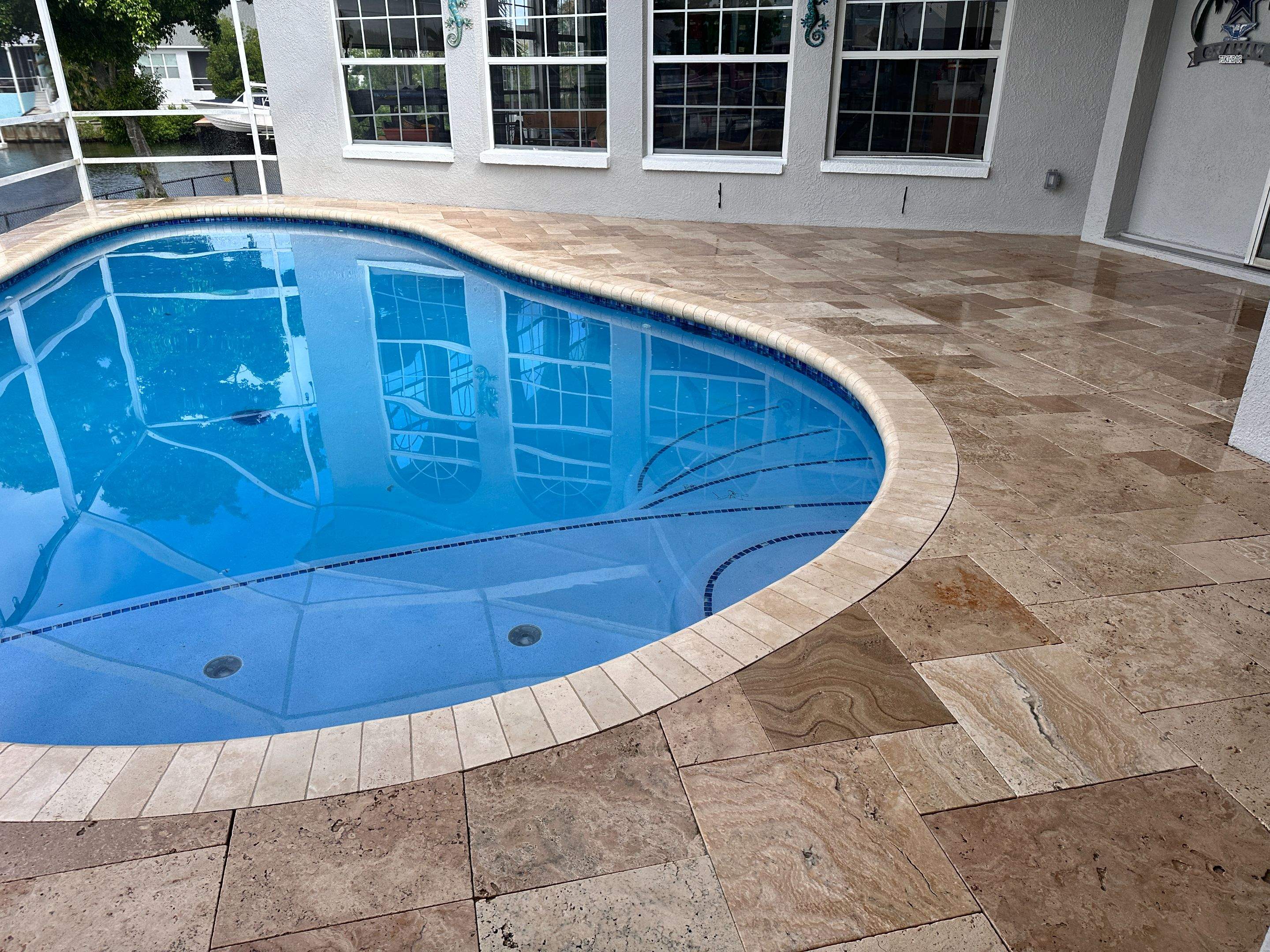 Travertine Sealing and Stripping for a Waterfront Pool Deck in Apollo Beach by Supreme Paver Experts
