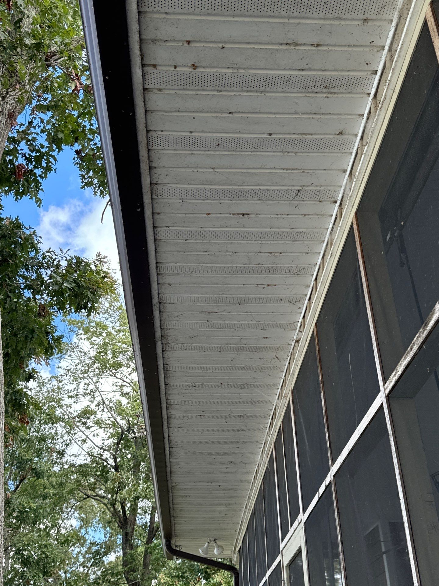 the service being done is cleaning the soffit and overhang area of the house to remove dirt and debris