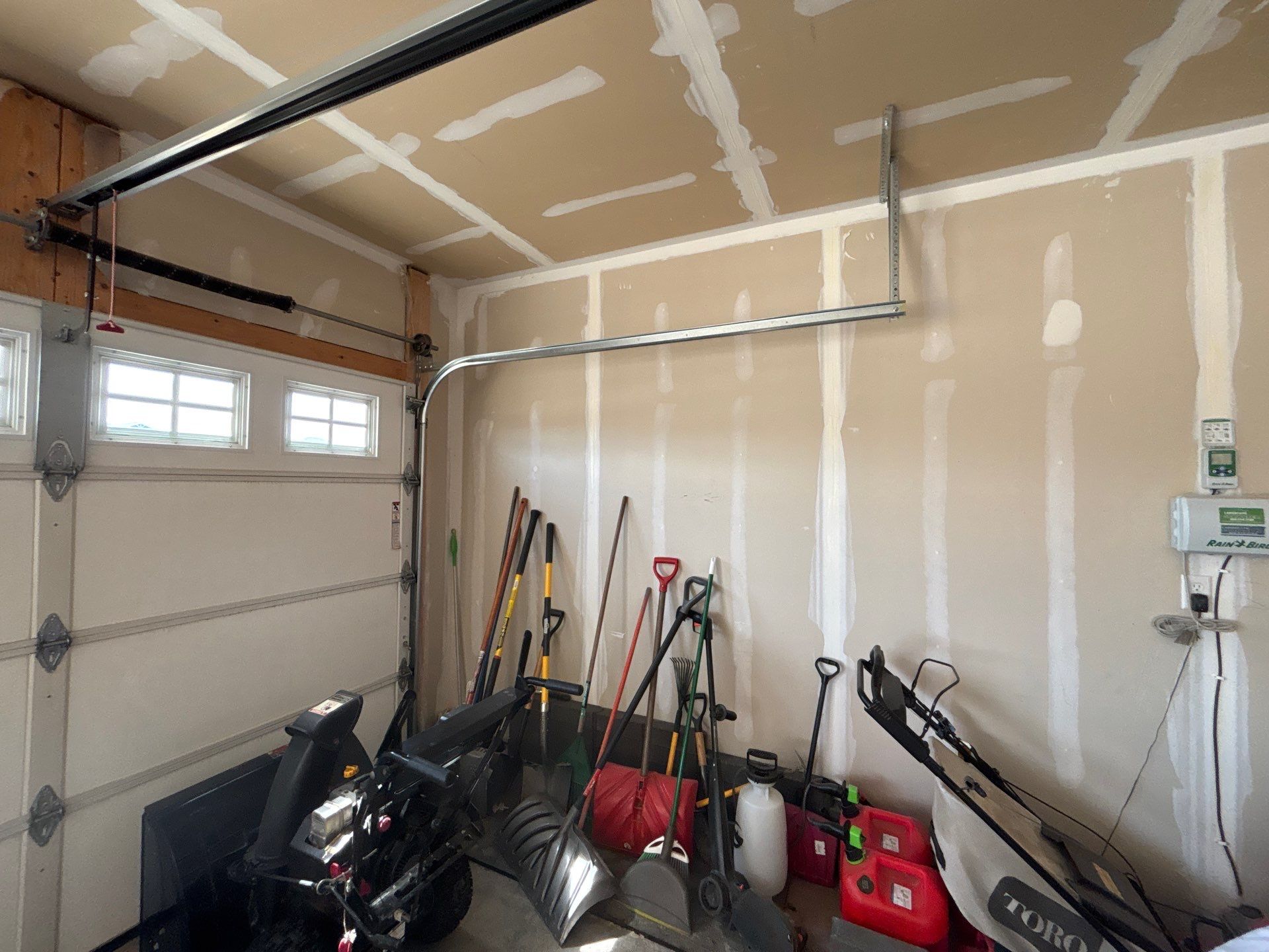 Grey Flake Epoxy Garage Floor Coating in Sioux Falls by Select Painting, Coatings & Garage Cabinets