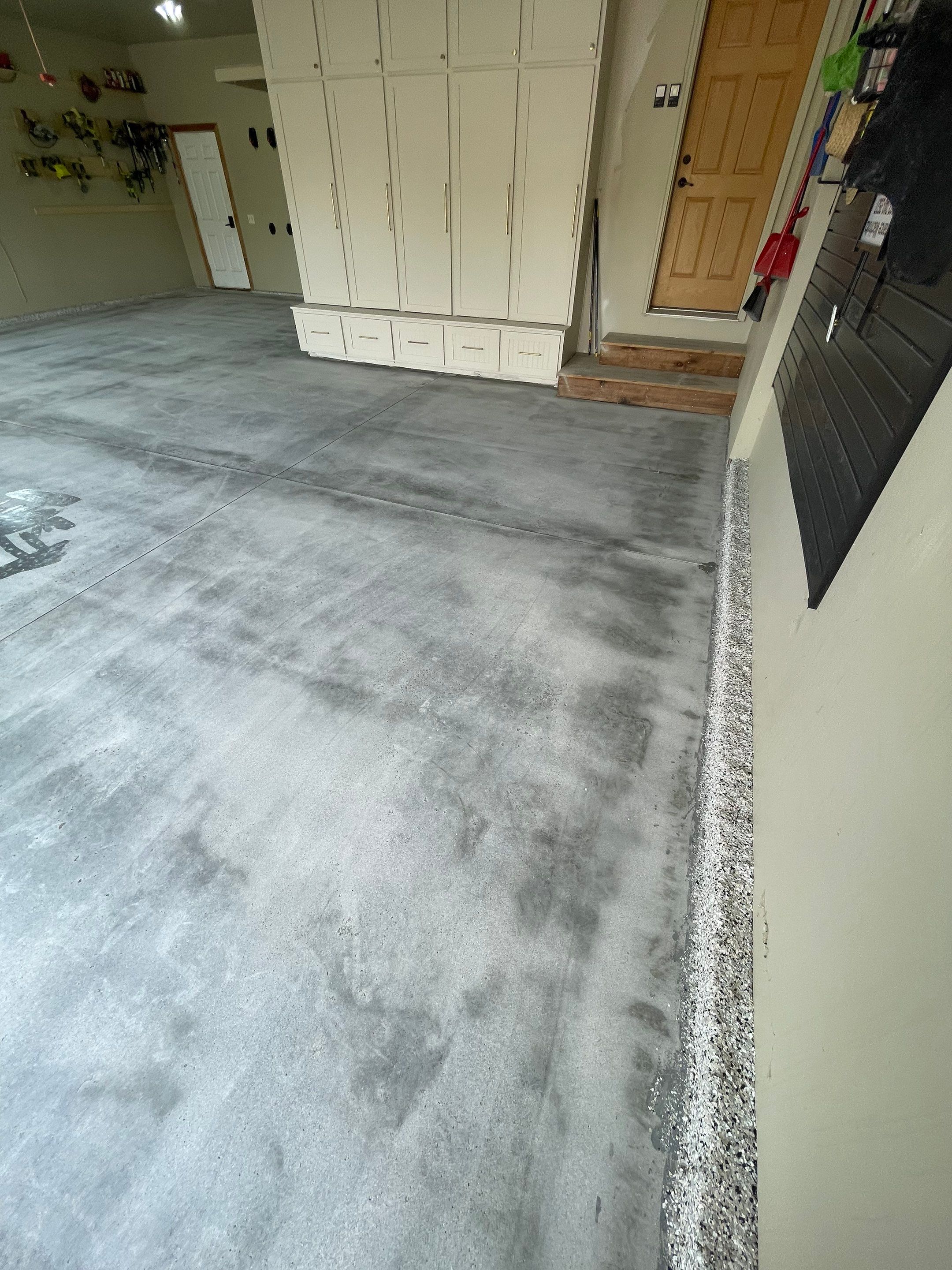 Cabin FEver Flake Garage Floor Coating Installation in Sioux Falls by Select Painting, Coatings & Garage Cabinets