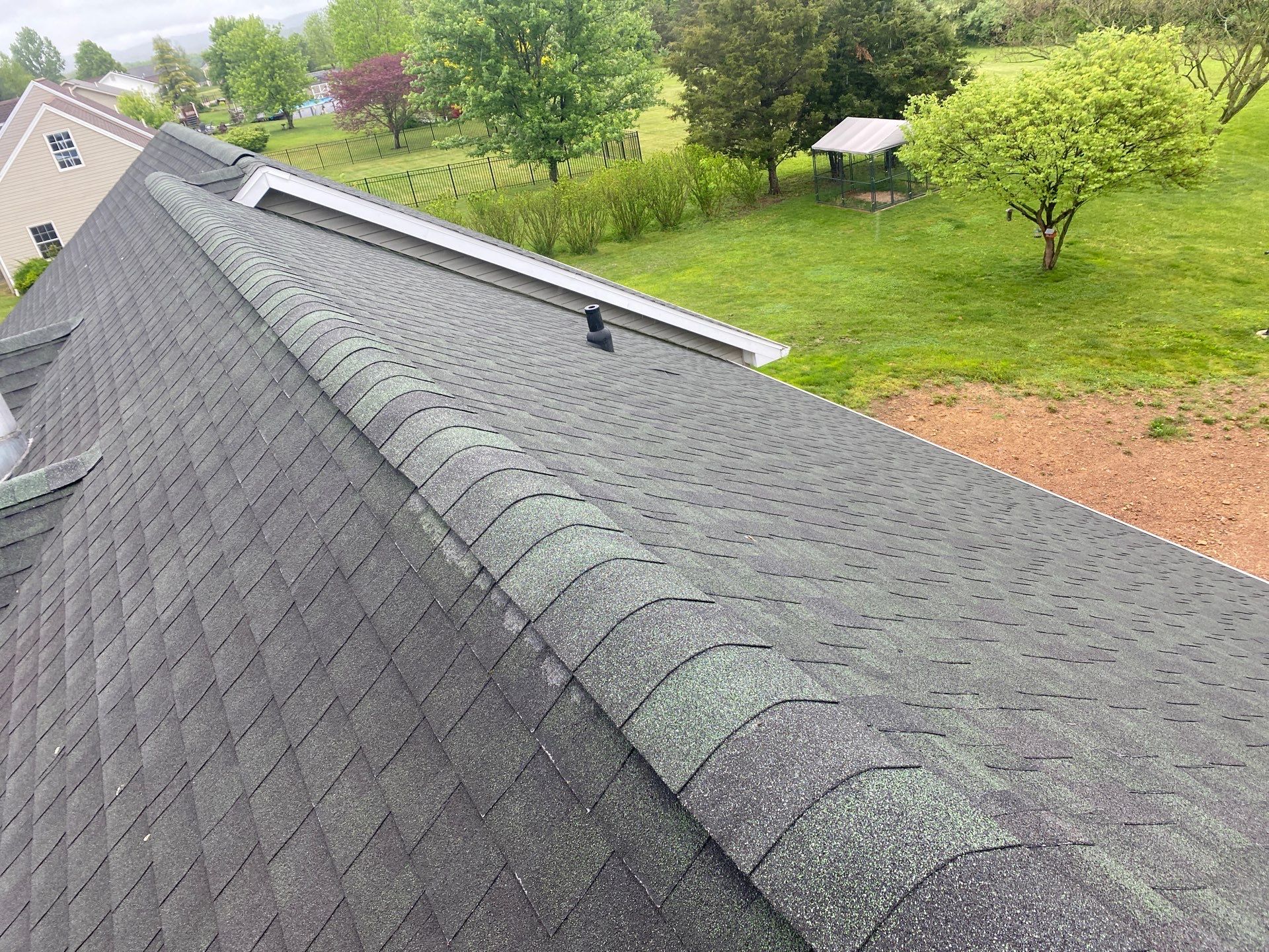 Green Metal Roof and Custom Covered Deck in Duncannon by Esh Builders