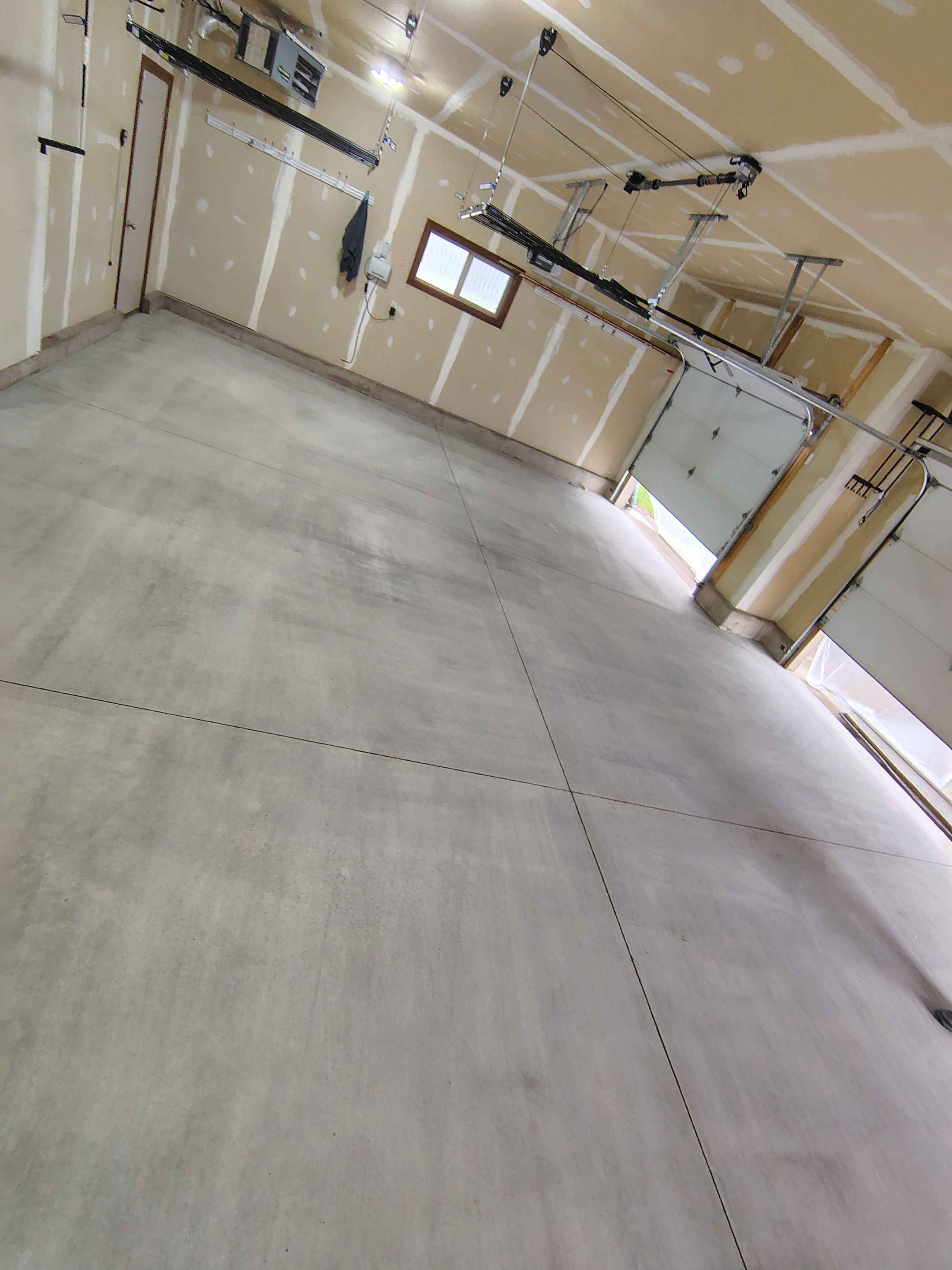 Multi-Car Garage Concrete Coating and Epoxy Finish in Sioux Falls by Select Painting, Coatings & Garage Cabinets