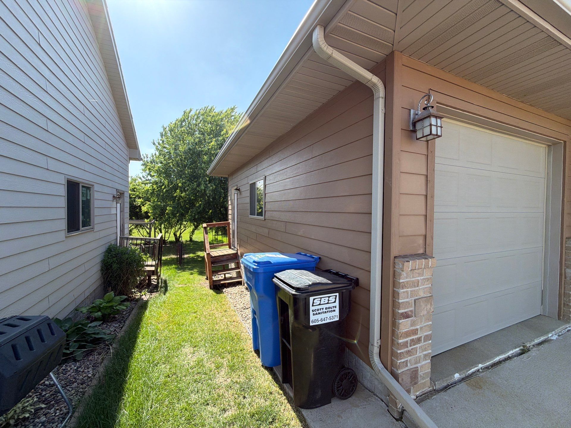 Full Exterior Residential Painting and Siding Refresh in Tea by Select Painting, Coatings & Garage Cabinets