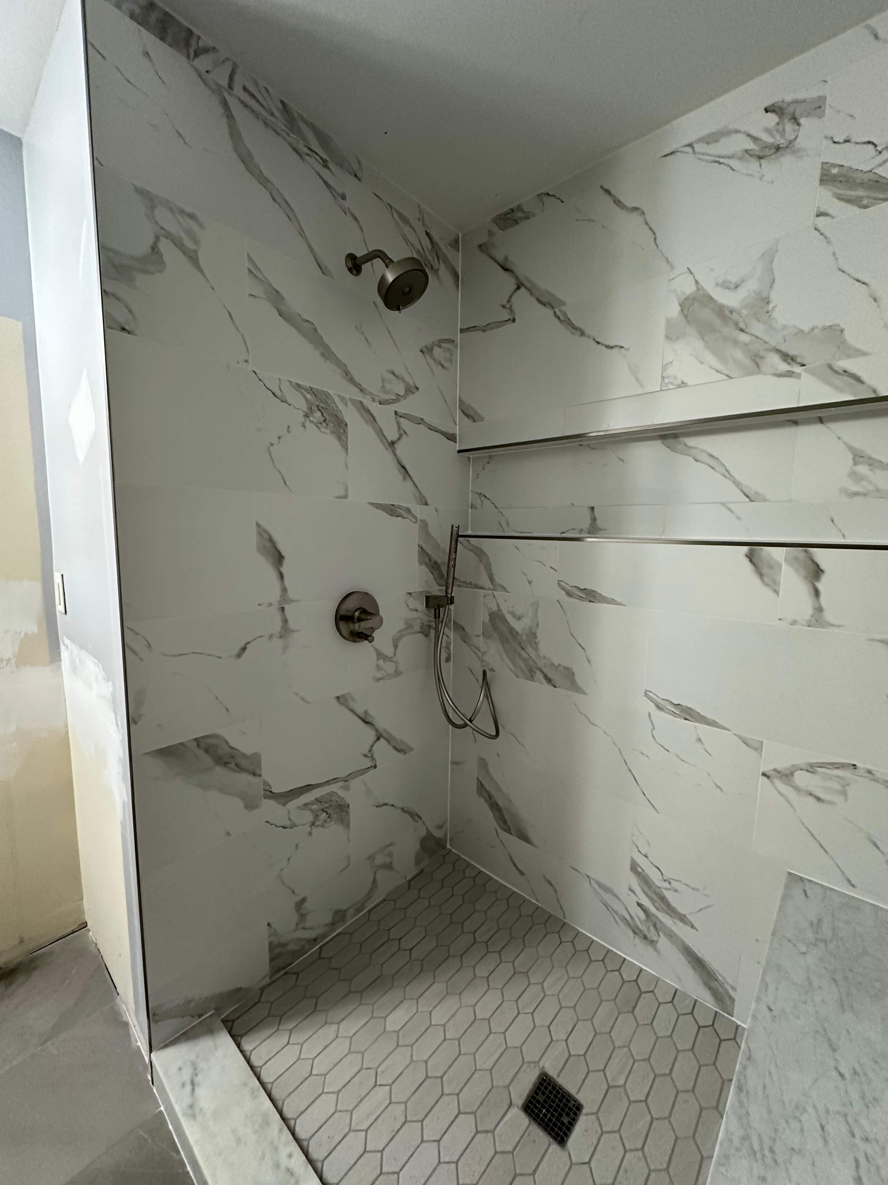 Tub to walk-in shower conversion, and tile flooring by Prudencio