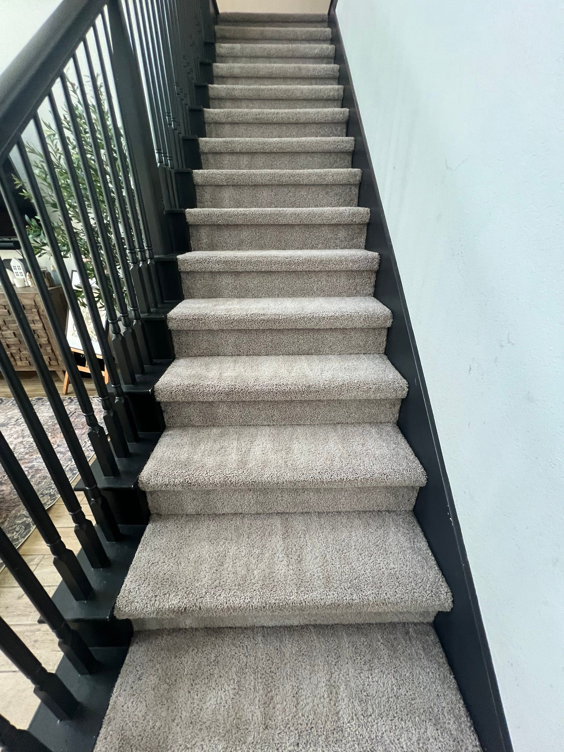 carpet cleaning company is cleaning carpeted stairs in a home in san antonio making them look fresh and clean