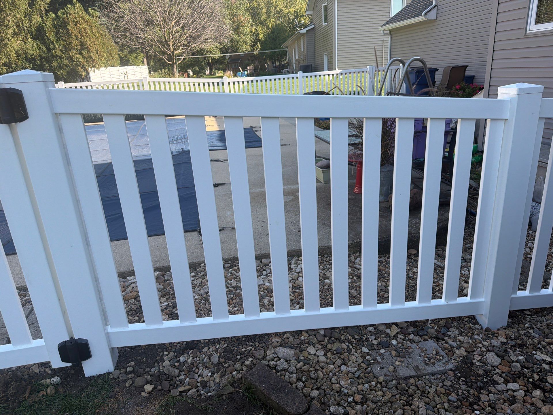 White Vinyl Picket Pool Fence Installation in Waterloo, Iowa by Perfect Picket Fence and Stain