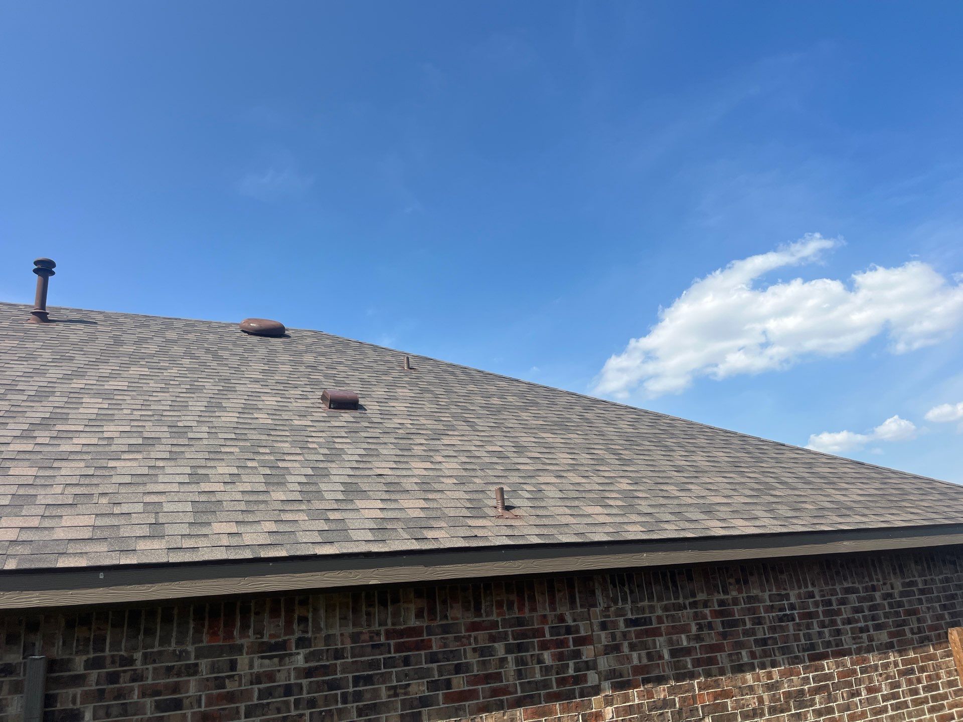 Medium brown brick with IKO Driftshake by Tejas Roofworks + Restoration