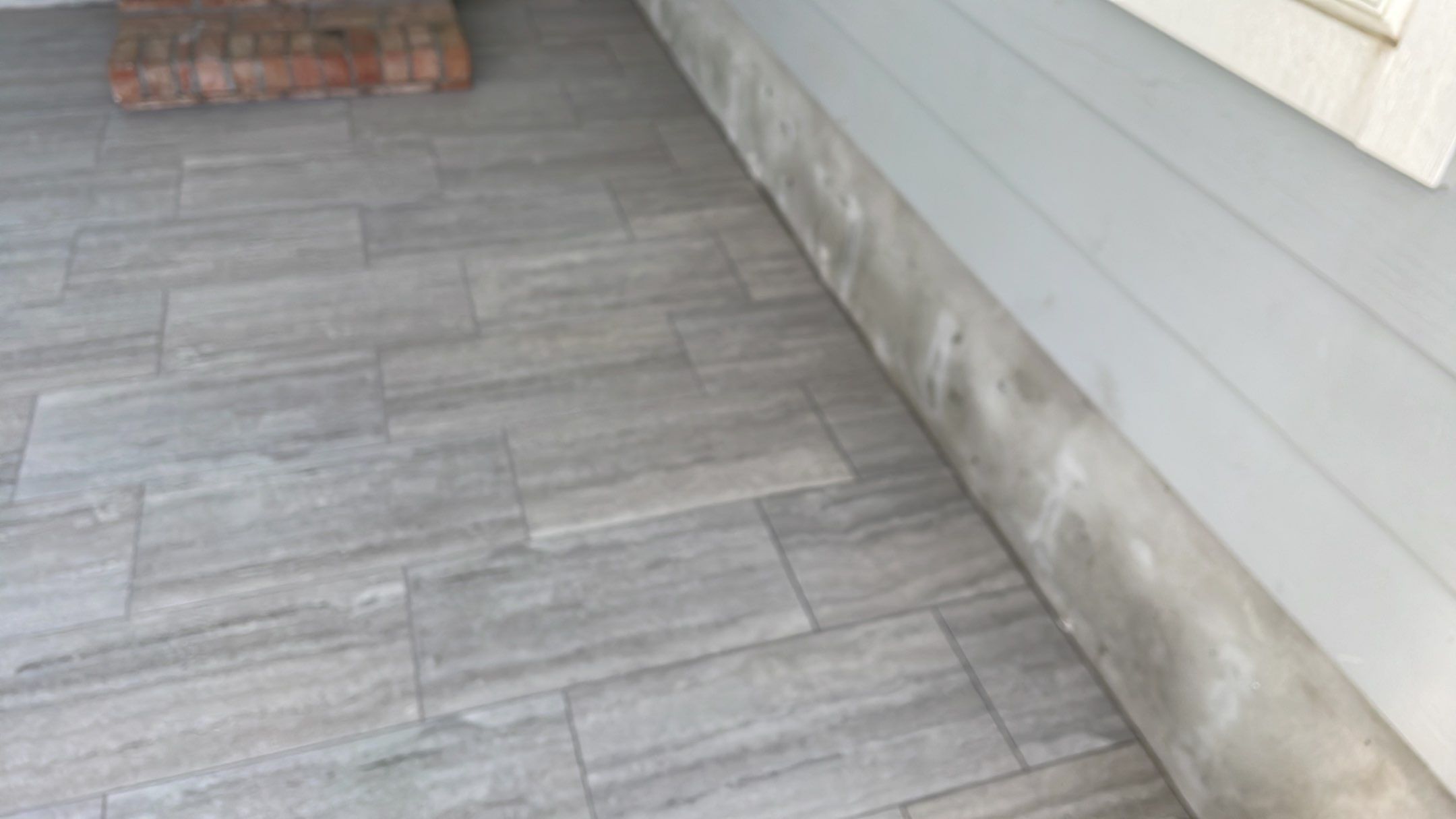Sunroom using 12x24 tiles by Footprints Floors of Coastal Carolina