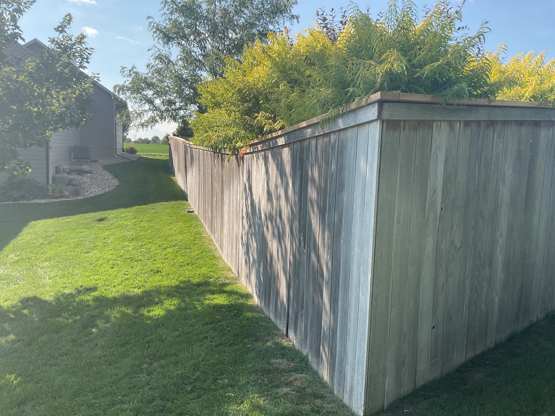 Custom Privacy Fence and Paver Patio Installation in Sioux Falls by Select Painting, Coatings & Garage Cabinets