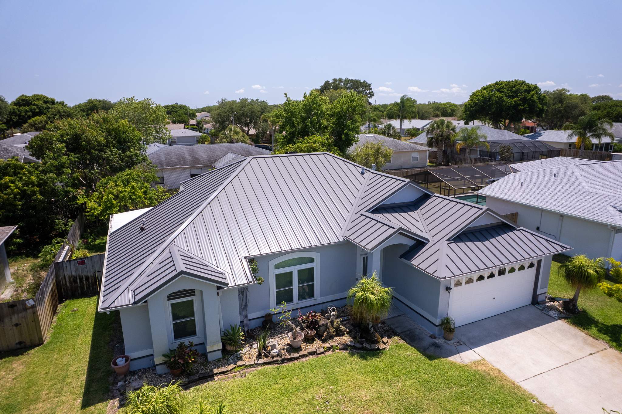 Complete Metal Roof Replacement and Seamless Gutter Installation in Melbourne by Wiedmann Construction & Roofing