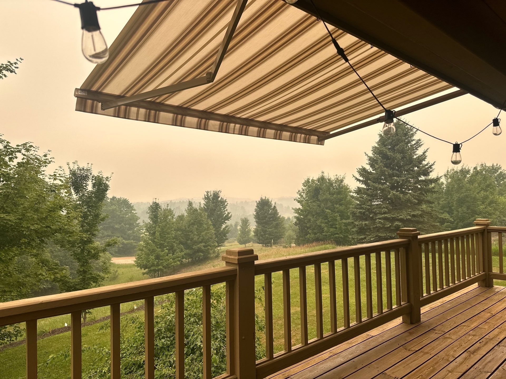 Custom Retractable Awning Installation for Boyne City Deck by Rainbow Seamless Systems
