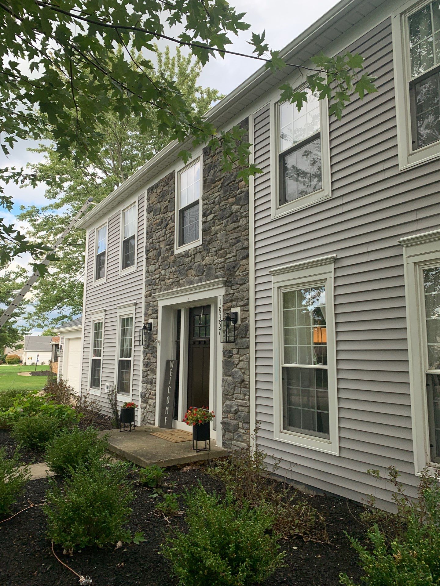 Vinyl Siding w. Stone Facade by Absolute Roofing and Construction