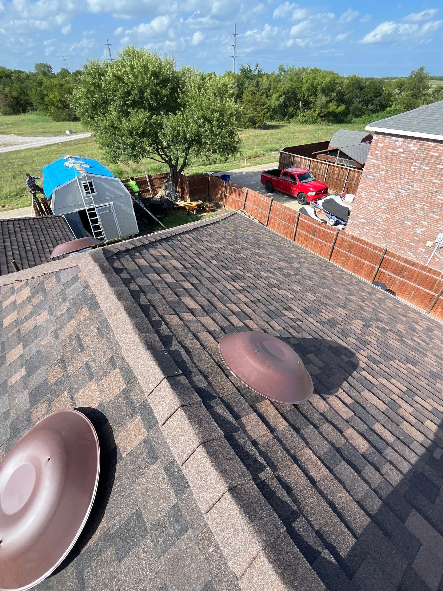 IKO Shadow Brown-Medium brown brick house by Tejas Roofworks + Restoration