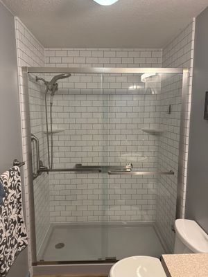 Jacuzzi Walk-In Shower Installation Featuring Subway Tile and Glass Doors