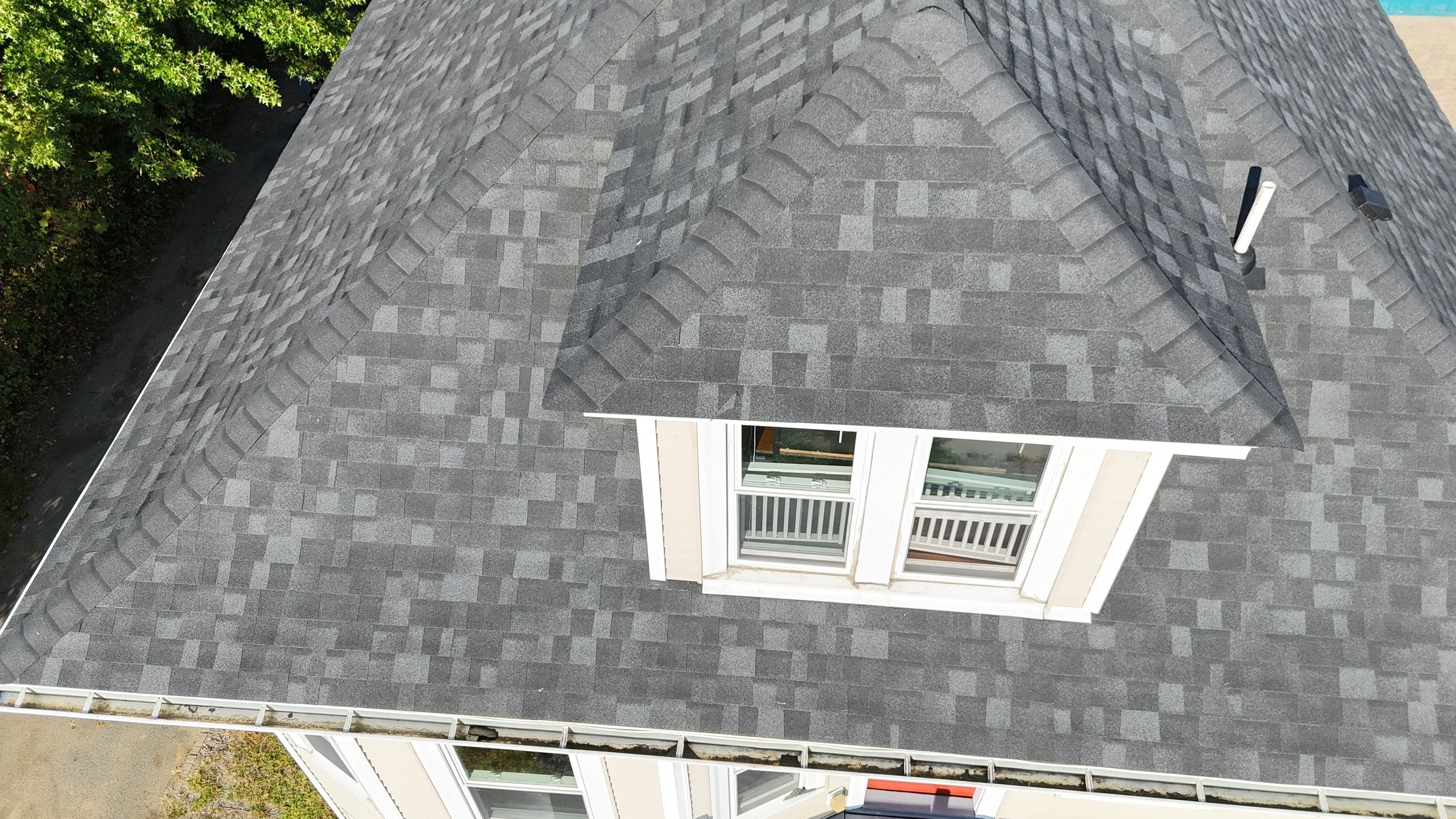 Roof Replacement with Skylight Flashing in Waltham, MA by Mighty Dog Roofing of Greater Middlesex County
