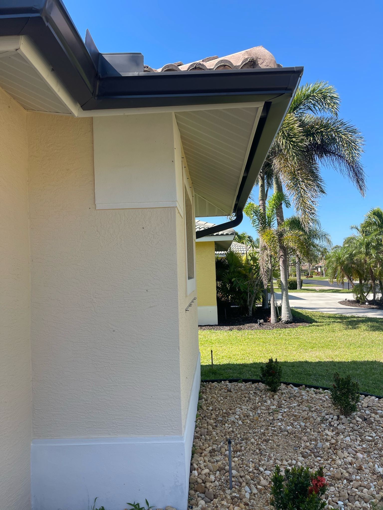 Bronze Seamless Gutters using 3X4 Elbow Downspout in Bonita Springs FL by Gutter Professors
