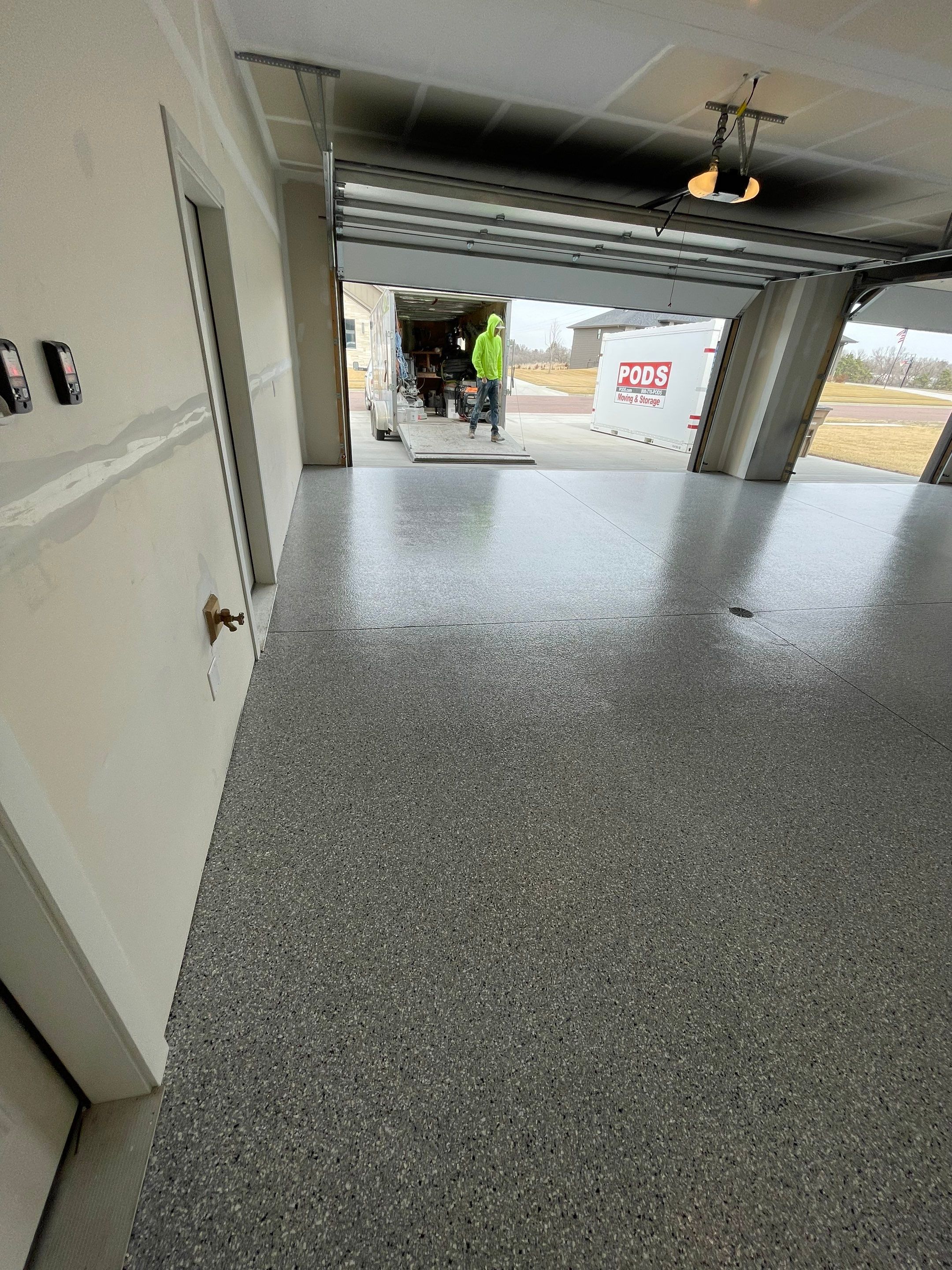 Grey Speckled Epoxy Floor Coating for Sioux Falls Garage by Select Painting, Coatings & Garage Cabinets