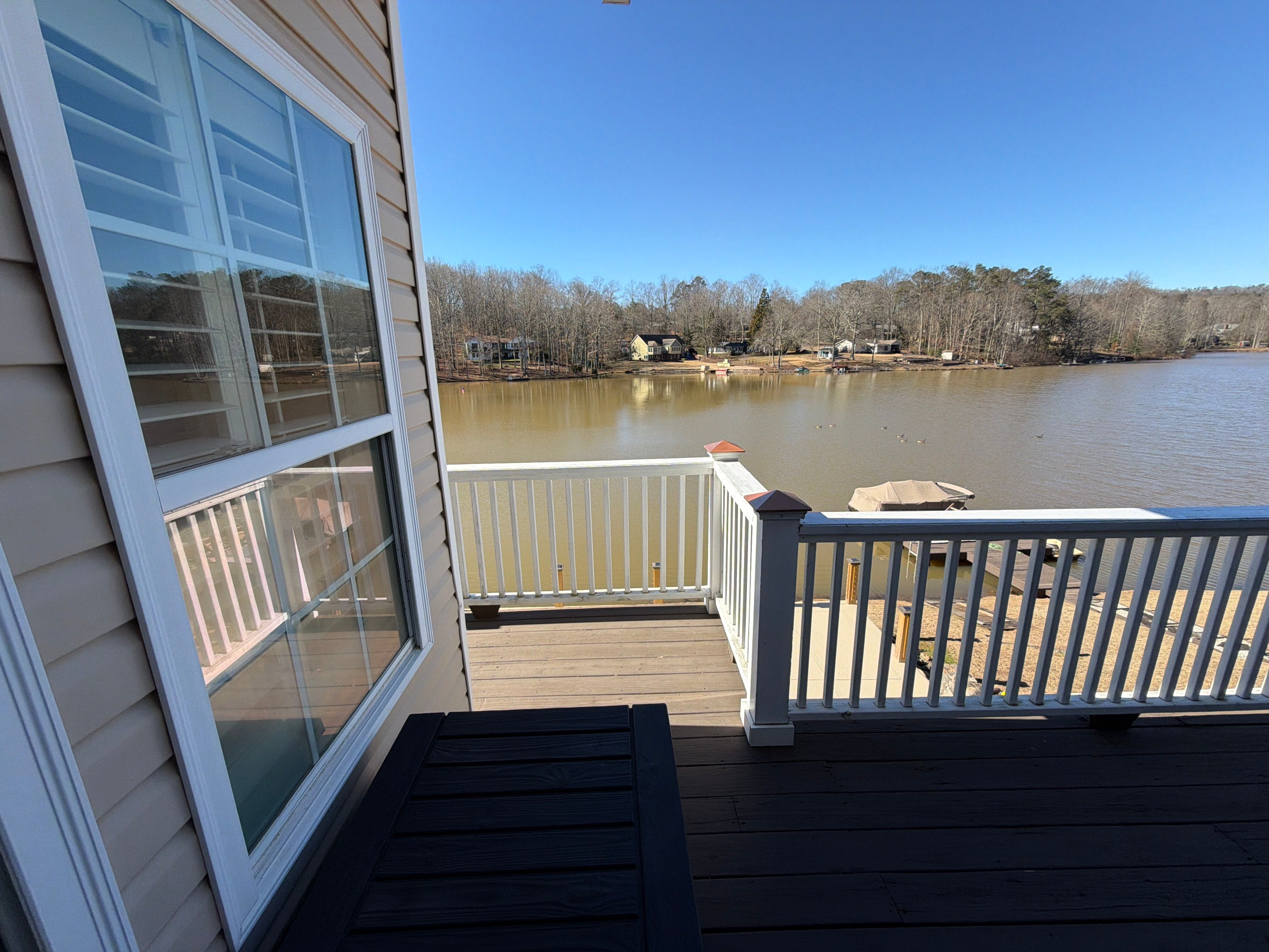 Cumming, GA Lake House Deck Resurface and Extension using Pressure Treated Pine and Skyline Cable Railing by Nelson Exteriors 