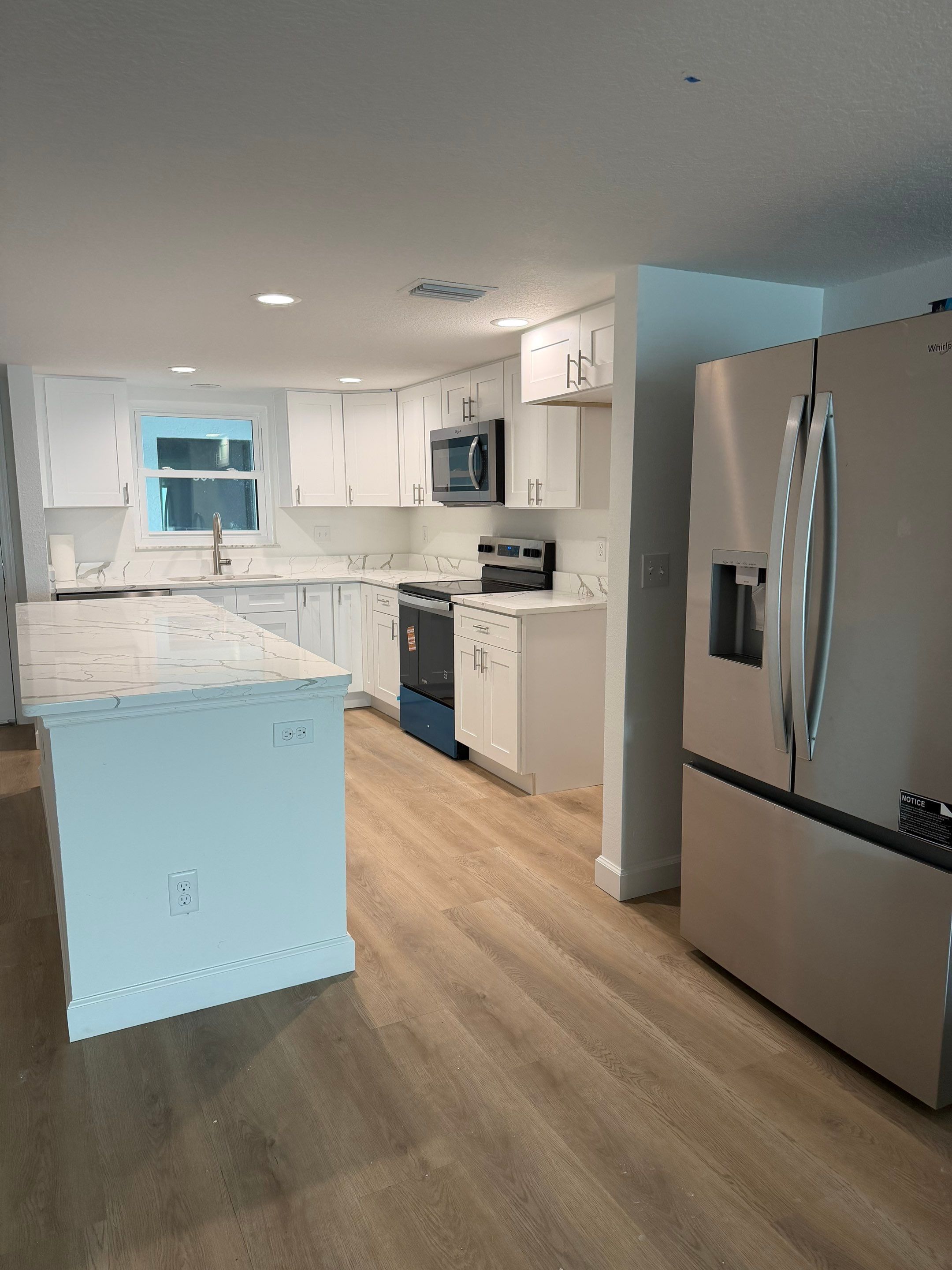 Full Condominium Remodel Featuring Aubrey Oak Flooring In Daytona Beach by Acies Renovations